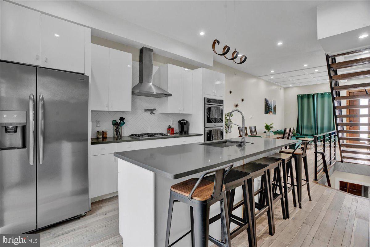 Welcome to 1526 S Stillman St, Philadelphia, PA! This recently built (2021) 4-bedroom, 3-bath home is the epitome of modern elegance. The moment you step inside, you'll be captivated by the open-concept layout on the 1st floor, which seamlessly blends the living room, dining area, and kitchen. Abundant natural light floods the space, complementing the inviting ambiance created by the warm wood flooring and recessed lighting. The kitchen is a chef's dream, boasting pristine white cabinetry, modern countertops, and high-end appliances. The convenience of a sliding glass door leading to the rear outdoor patio adds an element of indoor-outdoor living, perfect for entertaining or enjoying a relaxing evening. On the 2nd floor, you'll find two nicely sized bedrooms, each thoughtfully designed to provide comfort and functionality. The unique full bath on this level features a live-edge wooden top vanity, adding a touch of natural charm to the space. Ascend to the 3rd floor, and you'll discover the primary bedroom suite, your private oasis. Here, you'll be greeted by an abundance of natural light, ample closet space, and an en-suite bath that exudes luxury. The full bath includes a soaking tub, dual sinks, and a standing shower, providing the ultimate spa-like experience. But the luxury doesn't end there! The lower level of the home offers yet another full bath, a bedroom, and a convenient laundry area, ensuring that every need is met with ease. Last but certainly not least, the roof deck is a true highlight of this remarkable property. Offering picturesque views of the city, it's the perfect place to unwind and take in the sights. And to top it off, there's a hot tub, providing the ultimate relaxation and enjoyment all year round. 1526 S Stillman St is more than just a house; it's a place to call home, a haven of comfort and style that leaves nothing to be desired. Don't miss this opportunity to own a piece of Philadelphia's finest living. Schedule a tour today and make this dream home yours! 7 Years left on Tax Abatement!