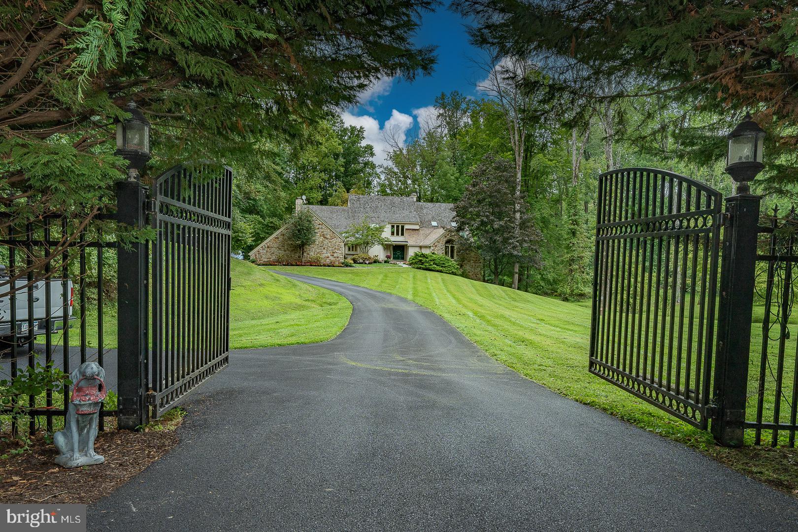 SPECTACULAR STONE & STUCCO MANOR ON 4.2 PRIVATE ACRES! Gated entry leads to this magnificent home offering stunning views & complete privacy. Premium Main Line location just 640' from Radnor Hunt Club, near charming Malvern borough & minutes to White Manor Country Club.
GRAND MAIN LEVEL: Soaring 20' marble foyer, sunken formal living room w/marble fireplace, elegant formal dining room, gourmet kitchen w/12' ceilings, breakfast bar, Jen-Air range, dual wall ovens, Sub-Zero refrigerator. Impressive family room w/20' ceilings, massive stone fireplace, sliders to deck overlooking pool. Private study w/14' beamed cathedral ceilings, powder room, laundry, pantry.
LUXURIOUS MASTER SUITE: Main level convenience w/fireplace, deck access to pool, dual walk-in closets, dressing area w/cherry cabinetry, spa ensuite w/separate shower & jetted tub.
UPPER LEVEL: 3 generous bedrooms, 2 full baths (1 ensuite), cozy reading nook overlooking family room.
LOWER LEVEL: Above-ground design w/natural light, oversized recreation room, movie area, bedroom, full bath, abundant storage/utility space.
PREMIUM FEATURES: Commercial backup generator, screened porch, pool/spa area, beautifully landscaped grounds. Easy access to trails, top schools, major roadways, PHL Airport, rail service.
Perfect balance of luxury, privacy & convenience in prestigious equestrian community. Must see!