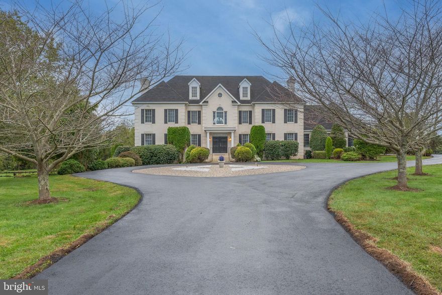 Price Reduction!!!  This is an estate sale but all the heavy lifting has been done.  Current improvements include HVAC systems, two water heaters, stainless steel appliances, driveway and roof.  Freshly painted throughout — a beautiful home is waiting for your personal touches.

This stunning luxury estate is situated on a gorgeous 5.8 acre lot with lovely views in sought after Barclay Ridge.  It is an all brick custom home with approximately 9,200 scanned square feet on three finished levels.  (Square footage determined when floor plans were completed.).  It is exquisite inside and out.  
Upon entering, the dramatic two story foyer sets the stage with a double staircase, crystal chandelier, and view to the back of the house.  As you pass through the foyer into the family room the elegance continues with architectural columns that introduce a soaring two story ceiling with recessed lighting and ceiling fans. The back wall of arched windows and a French door offers access to the deck with stairs to the extensive flagstone patio, pool, and spa.  

The large gourmet kitchen located at the back of the house, feels even more expansive due to the arched ceiling and wall of windows overlooking the scenic backyard. New stainless steel appliances, ample granite countertops, and beautiful Legacy cherry cabinets with Portofino Arch doors make it a pleasure to create culinary delights.  The island finishes it off with a cooktop, additional cabinets and more countertop space.  

Adjacent to the kitchen, the breakfast room with a beautiful brick wood-burning fireplace is a cozy space for casual meals or just to enjoy the fire.  The walk in pantry, laundry room and access to the garage is conveniently around the corner.  For formal events, there is a butler’s pantry with glass front cabinets, granite countertop, and sink. A perfect companion to the large dining room with crystal chandelier, decorative and crown molding.  

Finishing off this spectacular space is a first floor primary suite with spa-like bathroom.  This expansive room offers a gas fireplace, large sitting area with windows across the back, and two walk in closets.  The primary bathroom has all the bells and whistles including separate vanities, large jacuzzi soaking tub, separate shower, two linen closets, and water closet.

Walking up the stairs, another amazing view of the back and front of the house greets you.  The beautiful arched overlook to the family room is another dramatic feature.  There is a second suite with spa-like bathroom that mirrors the primary bathroom on the first floor.  Two additional bedrooms with ensuite bathrooms complete this floor.

The lower level is a great place to spend time with family and friends or entertain on a grand scale.  Enjoy the full size bar with Aristocrat Cafe cabinets, deep stainless steel under-mount sink, Haier beverage cooler, GE mini refrigerator and GE dishwasher.  A huge recreation room with wood-burning fireplace is a perfect place to lounge or entertain.  With access to the backyard, the swimming pool is only a few steps away!  Another large bedroom and full bathroom is perfect for visitors.  

A gorgeous conservatory is also accessed from the lower level.  Use your imagination on how to use this space.  It could be used as a dining area for a beautiful backdrop for holiday meals, or fill it with plants and comfortable seating to create an oasis from hot days by the swimming pool.  It would also make an ideal space for a home gym or a music room.

The exterior of the home is as amazing as the interior offering a beautiful swimming pool and spa with a waterfall feature that ties them together.  The extensive hardscape offers many areas to enjoy the outdoors. 

Barclay Ridge is located conveniently between Evergreen Mills Road and Route 50.  The location is perfect.  It feels like living in the country but is only minutes from everything one could need.