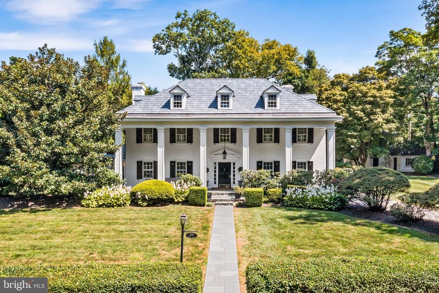 Mere minutes from Center City, this gorgeously renovated, Georgian-style colonial is nestled in a Main Line enclave of stately homes with quiet, tree-lined streets. Over the last decade, the current owners have spent over $750,000 updating nearly every inch of the property while taking great care to preserve its historic character and charm. A flagstone circular driveway delivers you to a grand, columned front porch paved in Pennsylvania bluestone. Inside, a bright and airy foyer with custom moldings, hand-painted mural and hardwood floors sets the tone for the immaculate first floor. To the right is an elegant, light-filled dining room with wainscotting, built-in China cabinet and tasteful millwork. Just beyond sits a sprawling kitchen-family room with vaulted ceilings, radiant heat flooring, custom banquette and dreamy backyard views. The renovated eat-in kitchen is a chef’s dream with its marble countertops; Sub-Zero® refrigerator; 48-inch Thermador® gas range with dual steam and convection ovens, warming drawer and custom hood; island seating; endless storage (including an appliance garage and coffee bar); wine fridge; and Fisher & Paykel® dishwasher drawers. The kitchen spills into a warm and welcoming family room with custom built-ins flanking a wood-burning fireplace. A California panoramic folding glass door offers easy access to a rear brick patio with plentiful dining and lounge space. A living room with marble-surround gas fireplace, a sunroom and a powder room with high-end fixtures complete this impeccable first floor. Take the beautifully preserved stairway to the second floor, where you’ll find a renovated primary suite that the owners ingeniously transformed to incorporate an impressive walk-in closet with marble-topped storage island and concealed laundry, plus a large ensuite full bath with radiant heat flooring and oversize marble shower with dual rain heads. The primary bedroom boasts coffered ceilings, plantation shutters, window seats and custom built-ins. This floor also includes two secondary bedrooms with closet organization systems, a full hallway bath and a rear staircase to the kitchen. The newly carpeted third level houses two additional bedrooms with dormers and window seats plus a spacious, renovated full bath with clawfoot tub, oversize shower and marble vanity. Steps away from the main house sits a two-story carriage house featuring a heated three-car garage and attached tool shed on the first floor and a one-bedroom suite with full kitchen and bath above. Beyond the home’s nearly one acre of partially fenced and professionally landscaped greenspace, endless attractions and conveniences await, including the Cynwyd Club, Cynwyd Heritage trail and Cynwyd train station (all within walking distance!). Enjoy award-winning Lower Merion Public Schools, low taxes and proximity to premier dining destination Pencoyd Landing too! Additional improvements include a newer roof, smart home security, designer lighting and fixtures, upgraded heating and cooling (including high-velocity AC), new exterior sewage pipes and interior plumbing, re-wired electric and more. Make plans to tour this meticulously maintained suburban marvel today!