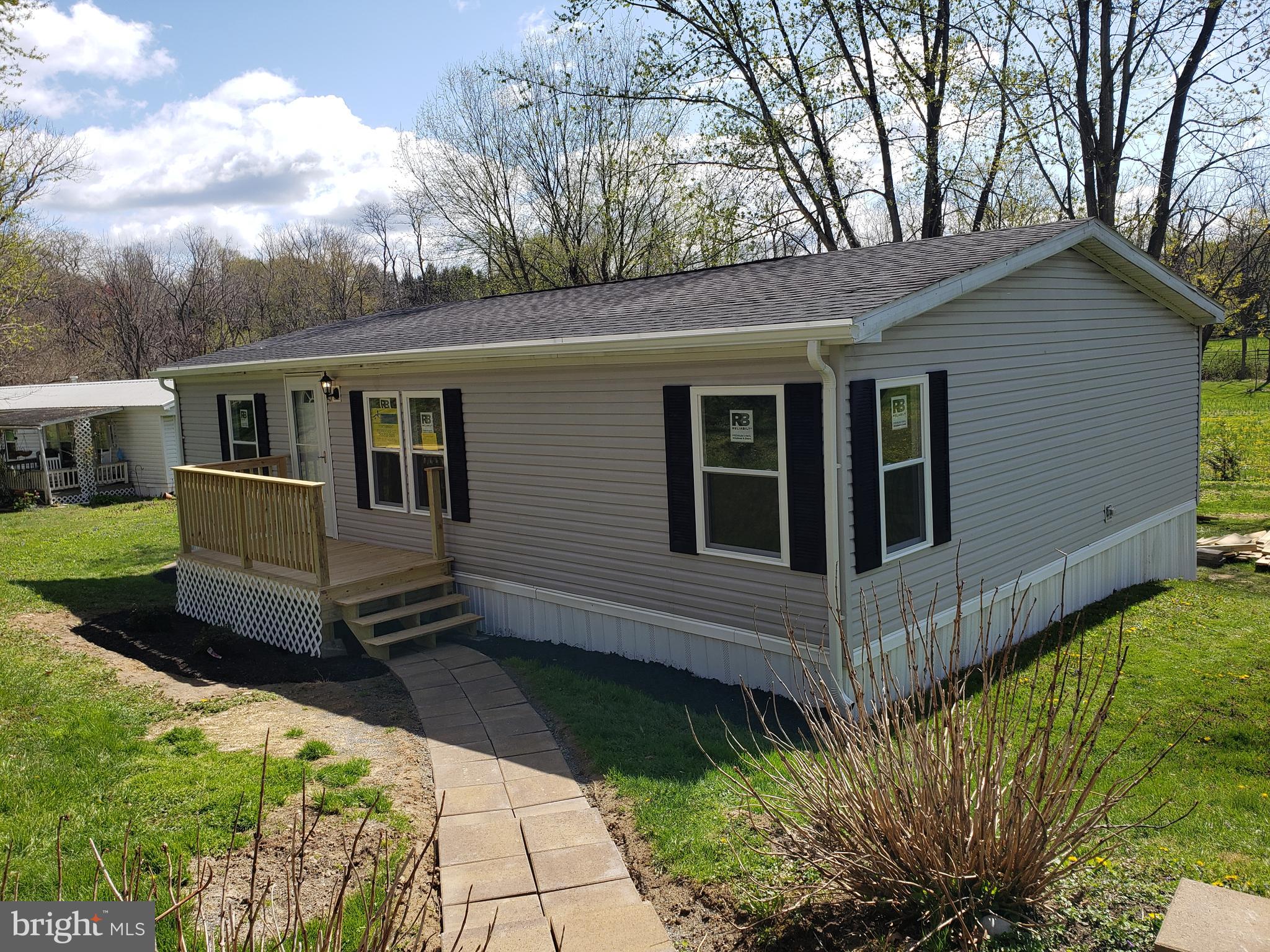 Completely remodeled double wide mobile home. 3 bedrooms and 2 full baths. Master suite with luxury bath and walk in closet. Everything has been done. This mobile is better than new with all the residential upgrades( not mobile home). The interior has been completely done. Everything is new. Upgraded kitchen cabinets with soft close doors and drawers. All new stainless steel appliances!! Completely new bathrooms!! Replacement windows( double hung tilt ins). New exterior and interior doors!! The list goes on and on. New front porch and rear deck. Home has a very nice large yard for a mobile home community. Country views out the back. Shed included. Lot rent includes sewer and trash.