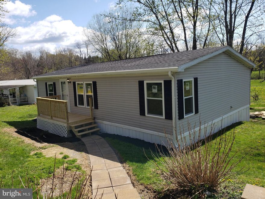 Completely remodeled double wide mobile home. 3 bedrooms and 2 full baths. Master suite with luxury bath and walk in closet. Everything has been done. This mobile is better than new with all the residential upgrades( not mobile home).  The interior has been completely done. Everything is new. Upgraded kitchen cabinets with soft close doors and drawers. All new stainless steel appliances!! Completely new bathrooms!! Replacement windows( double hung tilt ins). New exterior and interior doors!! The list goes on and on.  New front porch and rear deck. Home has a very nice large yard for a mobile home community. Country views out the back. Shed included. Lot rent includes sewer and trash.