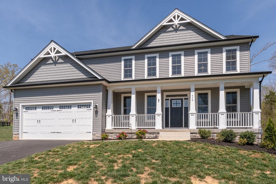 This stunning and upgraded WATER VIEW escape at Lake Anna, with nearby water access and your very own covered boat slip, was recently built in 2023.  This 4,400+ square foot home offers five spacious bedrooms, and is located in Elk Creek Landing—one of the area’s newer and more-popular subdivisions on Lake Anna's private side.   The main level features lovely LVP flooring, a first-floor bedroom, and a large living room with upgraded coffered ceiling, propane fireplace with beautiful mantle, and direct deck access.  The large upgraded kitchen - which opens up into the living room - showcases beautiful white quartz countertops, a large gas cooktop, stainless steel appliances, subway tile backsplash, pot filler, a large island, and a spacious pantry.  The large rear deck with a propane gas stub provides an easy outdoor setup overlooking your large backyard.   The second floor features LVP as well, and features four additional bedrooms, including a large primary suite with water views, walk-in closet with shelving, and a large bathroom featuring elegant tile flooring, a double vanity, standalone soaking tub, and large walk-in tile shower.  Three additional bedrooms upstairs, one of which is another primary suite with bathroom, plus another full bath upstairs and a convenient laundry room.  The massive walk-up unfinished basement offers expansion potential with plumbing rough-ins for a future bathroom.  Additional features include a large two-car attached garage, a spacious covered front porch with lake views, and an expansive private backyard.  GREAT location,  just minutes from local dining, groceries, vet clinic, ABC, The Lake Anna Taphouse, local coffee shop, and more.   Less than an hour from Richmond, Fredericksburg, and Charlottesville, and just 82 miles from Washington DC.  Short term rentals are permitted in this subdivision.