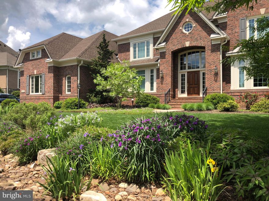 Desirable  Red Cedar West community. This Gulick Winthrop Model graces an exquisite 1+ acre lot, backing to HOA Conservancy space.  4 bedrooms with 4 full baths up. Wildflower meadow in the back, year-round perennials, mature landscaping. Stone, brick and quality finishes throughout.

Superb floorplan with  5,440 square feet above grade includes structural options like 5th bedroom, conservatory and sunroom.    Gourmet kitchen, including a double wall oven, gas cooktop, and dual dishwashers. Custom cabinetry, an oversized island, and a butler’s pantry.  Mudroom and laundry located just off the kitchen and the garage.

The main level is a testament to gracious living, featuring a family room with a fireplace, a sophisticated study, and formal living and dining areas. The conservatory, with its grand two-story ceiling and plantation shutters, invites abundant natural light. Spacious four bedrooms and four full baths are thoughtfully placed on the upper level, highlighted by a luxurious primary suite with a sitting room and dual walk-in closets. Sanded-in-place hardwoods.

The walkout lower level includes a bedroom, gym, media room, and full bath, with additional space primed for your vision. Outdoors, a stone shed is surrounded by natural sedge grass,  low-maintenance native grass. An oversized three-car garage with extra height.
Upgraded Andersen windows. 

Ideally positioned just minutes from Rt. 7 and Dulles Toll Road, 20 minutes to Dulles Airport.