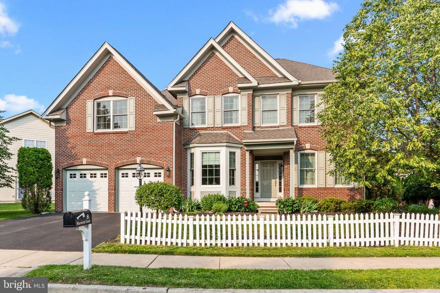 Stunning Brick-Front Colonial in a Prime Location.  
Welcome to this beautifully appointed 5-bedroom, 2.5-bath home that seamlessly blends classic charm with modern convenience. Featuring a timeless brick front exterior, a white picket fence, and a 2-car garage, this home is nestled in the desirable Wilkshire Walk community, a sidewalk-lined neighborhood that is perfect for walking and biking.  
Step inside to gleaming hardwood floors throughout, enhanced by decorative moldings and an open floor plan that flows effortlessly from room to room. The heart of the home is the chef’s kitchen, equipped with 42” cabinets, a center island, pantry, stainless steel appliances, tiled backsplash, and recessed lighting—ideal for both entertaining and everyday living. A large and bright morning room, flooded with natural light from abundant windows, opens to a paver patio and private back yard perfect for outdoor relaxation.
Enjoy cozy evenings in the dramatic 2-story family room, highlighting a wall of windows and a gas fireplace. The walkout basement offers endless potential for additional living space, a gym, or a media room.  
Upstairs, you will find five generously sized bedrooms, including a luxurious primary suite with a tray ceiling and a spa-like bathroom featuring a double vanity, deep soaking tub, and separate shower. The hall bathroom also offers a double vanity, tub, linen closet, and a charming transom window.
Convenient second-floor laundry and abundant storage throughout complete the interior features.
Within 5 minutes is downtown Newtown Boro with highly rated restaurants and quaint shops. And, located within a mile of Roberts Ridge Park, enjoy direct access to 22.8 acres of recreational space with an inclusive playground, walking trails, and picnic areas. The Newtown Trail running through the community connects you to Newtown Borough, Silver Lake Park, Chandler Fields, and Tyler State Park for endless outdoor enjoyment.
With easy access to trains and major routes, commuting to Philadelphia, Princeton, or New York is effortless. Just 20 minutes to Mercer Airport, this home truly offers luxury, location, and lifestyle—all in one perfect package.