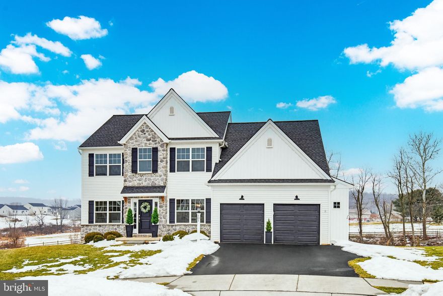 If you’ve been waiting for a home that feels like it was pulled straight from the pages of a magazine but still lives comfortably every single day, 101 Darlington Ct might be the one. Built in 2022, everything still feels fresh, stylish, and thoughtfully designed, with over 3,000 square feet above grade and nearly 1,000 additional finished square feet in the daylight walkout basement to spread out and enjoy. From the moment you step inside, you’ll notice the custom trim, chic accents, and the kind of finishes that make each room feel intentional. The kitchen is truly the heart of the home, featuring quartz countertops, a generous island perfect for gathering, stainless steel appliances, and soft-close cabinets and drawers that add both beauty and function. Whether it’s busy school mornings or hosting friends on the weekend, this space was made to bring people together. Upstairs, five spacious bedrooms offer room for everyone, including a stunning primary suite that feels like a private retreat. Vaulted ceilings, beautiful trim work, and a standalone soaking tub tucked into the corner create the perfect place to unwind at the end of the day. Need even more flexibility? The main level flex room can easily serve as a sixth bedroom, office, or playroom depending on your needs. Downstairs, the finished walkout basement opens up even more possibilities with a theater or flex room complete with projector, an additional family room, and a separate space ideal for a home office or workout area. There’s still plenty of unfinished storage, so you don’t have to sacrifice practicality for finished space. With three-zone heating and cooling, every level stays comfortable year-round. Step outside and the setting truly sets this home apart. The stamped concrete patio stretches beneath the deck and overlooks a spacious backyard with a King Swings playset and beautiful views of a spring-fed pond. Beyond the preserved neighborhood space sits an active Lancaster County farm, giving you peaceful, scenic views that are hard to find. The modern farmhouse exterior with natural stone and wood accents adds to the home’s curb appeal, and the two-car garage includes a convenient storage bump-out for bikes, a mower, or extra gear. At 101 Darlington Ct, you’re not just buying a beautiful, like-new home, you’re stepping into a lifestyle that blends style, space, and scenery in all the right ways.