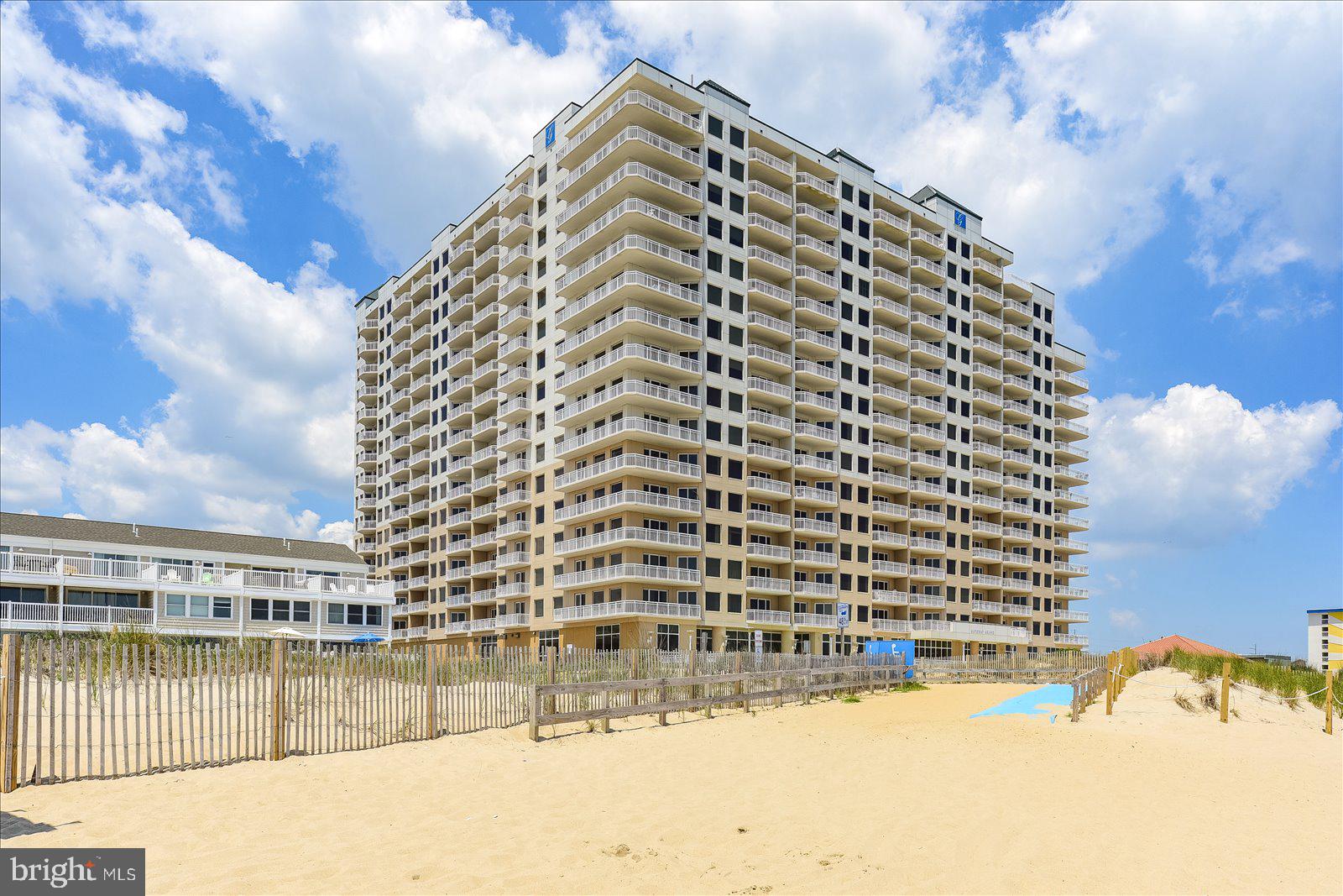 Note: Buyer paid all Seller closing costs inclusive of Commissions, Transfer Taxes, etc. total: $68,026.84.
Coastal elegance best describes this direct oceanfront 3 bedroom residence at The Gateway Grand. Interior upgrades include crown molding and chair rail in the entrance hallway along with modern wall scones. You will also take note of custom millwork in the primary bedroom and dining room. This former model home also boasts a tile backsplash in the kitchen along with pendant lighting at the oversized kitchen island. Entertain your friends and family on game day in the living room with a large TV with surround sound speakers. The 9th floor location is ideal providing panoramic ocean and beach views. This property was never rented by its current original owners and it shows! That said, if you are looking for an investment property, it would be an excellent rental. The Gateway Grand complex features an abundance of luxurious amenities including 5 high speed elevators, a spectacular lobby with staffed front desk, parking garage with covered bridge to access the building along with electric car chargers for owners, heated indoor and outdoor pools, 24 hour fitness center with pool and ocean views, kid's activity room, deeded beach storage locker, and the list continues. Come see what The Gateway Grand has to offer you and your family in Ocean City, Maryland! Deeded ground floor storage locker #44 conveys with residence.
