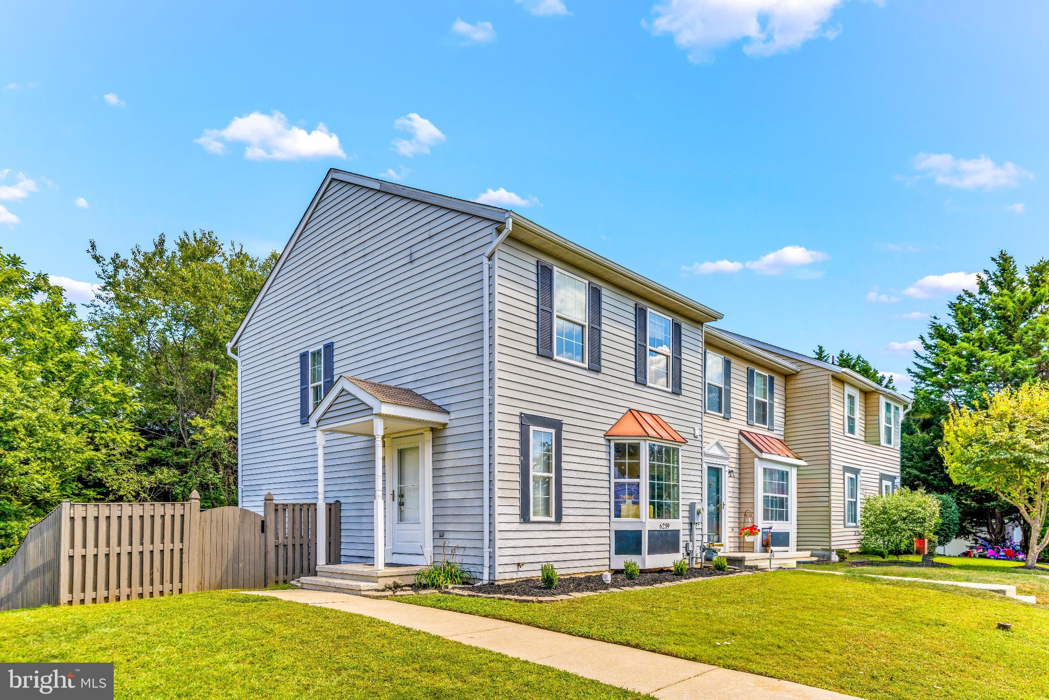 Rarely available spacious end-unit townhome that has all the extras you’ve been hoping for. You'll love the upgraded kitchen, bathroom & LVP flooring. The main level floor plan is spacious and open, with plenty of natural light. The home sits in the rear of the neighborhood, backing to woods, for a quiet and peaceful setting. Boasting one of the largest and fully fenced lots - with a bonus side yard and common space directly adjacent - it's perfect for play, pets, and relaxing outdoors. The location couldn’t be more convenient, walking distance to shopping, dining, and commuter routes just minutes away, yet still maintaining the charm of a quiet neighborhood. Plus, you’ll love being in one of the area’s top-rated school districts. These end units backing to woods don't come around often—so don't delay, and see it for yourself!