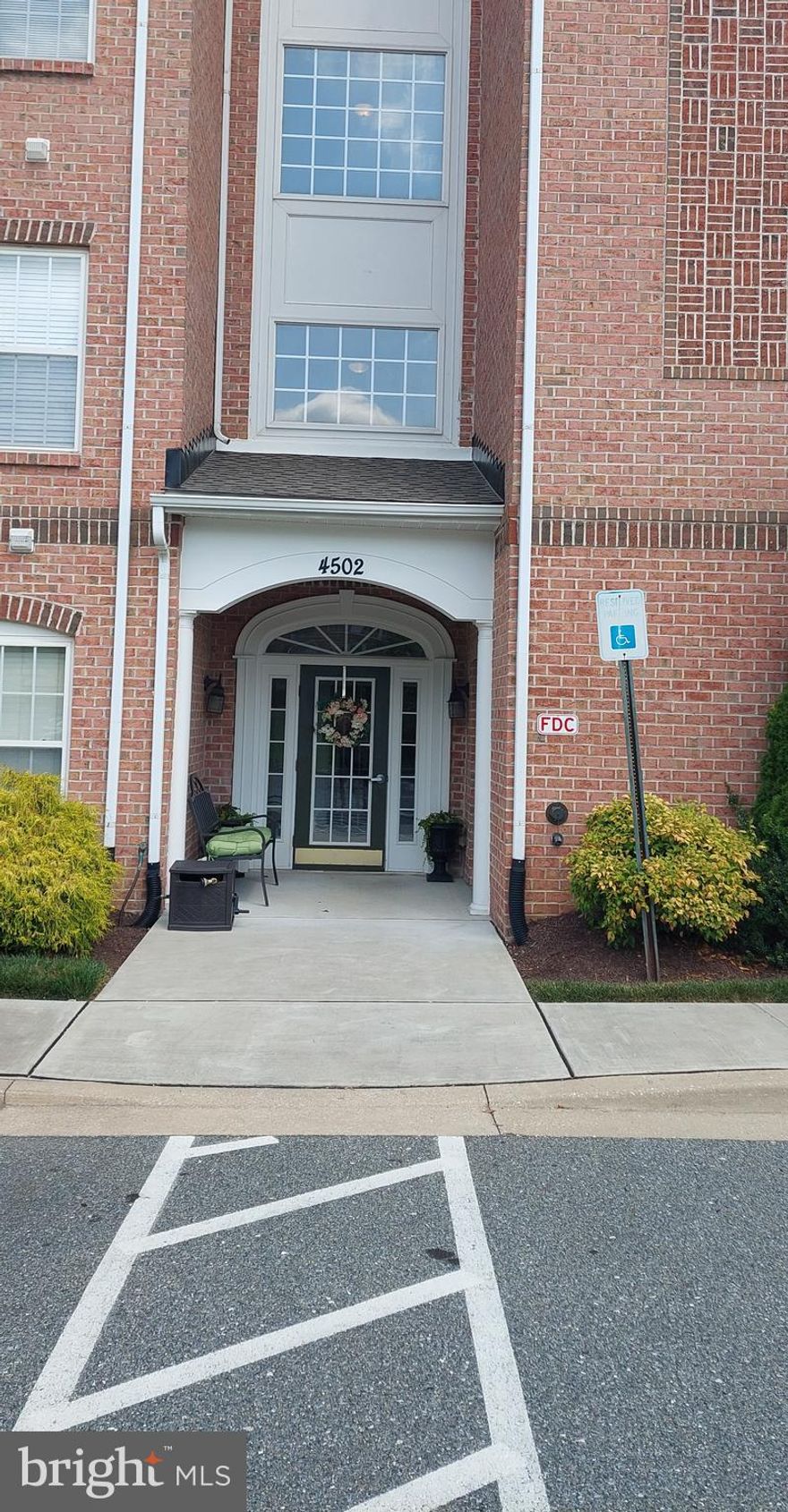 Don't miss the opportunity to own this beautiful penthouse condo in the sought after community of Windsor at Perry Hall Farms.  Convenient to everything, the ample parking and secure entry building make this community a gem.   This penthouse unit is a quiet retreat with no noisy neighbors above you.   As you enter the condo through the beautiful hardwood foyer,  the spacious open concept living room with separate dining area, fireplace,  crown molding,  chair rail,  and vaulted ceilings are sure to impress.  Perfect for entertaining, this area also opens to a separate breakfast room with door to private balcony bringing in plenty of natural light.  The well equipped kitchen boasts Corian countertops, ample cabinetry, a pantry, a peninsula with seating,  and all appliances convey.  The laundry area is conveniently located across the hall from the kitchen,  and includes the washer and dryer.  The popular split floorplan ensures plenty of privacy,  with the second bedroom and full bath on one side, and the spacious primary suite on the other.  The  primary suite provides a quiet retreat with a seating area, large walk-in closet, and an ensuite bath.  The second bedroom has a large closet and is right next to the second full bath.  There is a large in unit storage closet off the foyer, with an additional locked storage room in the building just across the hallway.  The unit is freshly painted with new carpeting, new hot water heater and microwave.  The condo comes with one assigned parking space,  and tons of unassigned parking.  Minutes from multiple shopping and dining options,  public parks, library, and Route 1 and 95,  this exceptional penthouse is truly convenient to everything!