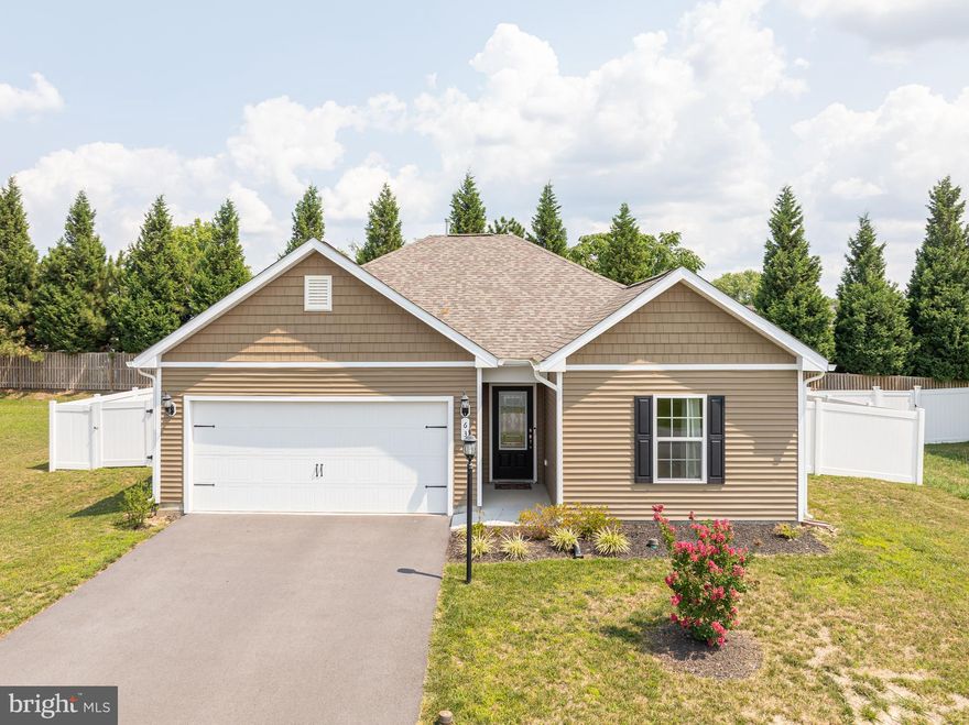 Why wait for a new home when you can move into this beautiful, well-maintained 3-bedroom, 2-bath ranch-style home today? This gem is nestled just outside the Martinsburg city limits in the desirable McGinnis Point community. Step inside to find upgraded flooring welcoming you in the foyer, with two spare bedrooms and a full bath conveniently located to the right. The home features a convenient laundry room and easy access to the garage. The heart of the home is a spacious open floor plan that includes a bright living room, dining area, and an upgraded kitchen with stainless steel appliances, granite countertops, a breakfast bar, recessed lighting, and a large pantry. The primary bedroom, located off the living room, boasts a private full bathroom with an oversized shower and a walk-in closet. Enjoy outdoor living with access from the dining area to a generously sized concrete patio and a fenced backyard that backs to trees, offering privacy and tranquility. This home won’t last long—schedule your showing today!