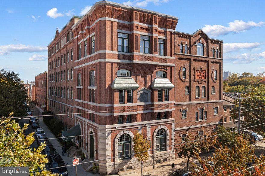 Incredible value at the Historic Brewery Condominiums—an iconic Fairmount area gem with gated parking and modern touches! Originally the Bergdoll Brewery Building, this beautifully maintained condo at 825 N 29th Street, Unit 5G blends historic charm with contemporary convenience. This oversized studio, with its smart layout, can easily be converted back to a one-bedroom with a simple wall addition—offering long-term flexibility and value. Step inside to high ceilings, classic light hardwood floors, and stunning brick archway windows that flood the space with incredible natural light. The entryway welcomes you with dual oversized coat closets, leading into an open-concept living, dining, and kitchen area that feels both spacious and inviting. Historic details throughout the home add warmth and unique character. To the left of the main living space is a cozy sleeping area comfortably fitting a queen bed, dresser, and a large closet. Toward the back, you'll find an updated stacked washer and dryer, a dressing area with a modern vanity framed by white subway tile, and bright lighting. The adjacent full bathroom features a clean, timeless design with light-colored tile and a tub/shower combo. Off the dining area, the modern galley-style kitchen boasts sleek beige countertops, white cabinetry, and stainless steel appliances—perfect for home cooks and entertainers alike. This unit is located in a pet-friendly elevator building with excellent community amenities, including a serene courtyard with grills and seating, bike storage, and a rooftop deck with breathtaking views of Fairmount Park, the Art Museum, and the Philadelphia skyline, making it the perfect spot to relax, watch fireworks, or take in the sunset. Situated at 29th and Parrish Streets, this condo is steps away from Fairmount Park, Boathouse Row, and the Philadelphia Museum of Art. The vibrant Fairmount and Brewerytown neighborhoods offer an abundance of cozy cafes, acclaimed restaurants, and lively bars, all within walking distance. With easy access to public transportation and major roadways, commuting and exploring the city couldn’t be easier.  Best of all, you’ll come home every day to secure gated parking, making this condo a rare find in one of Philadelphia’s most desirable neighborhoods!