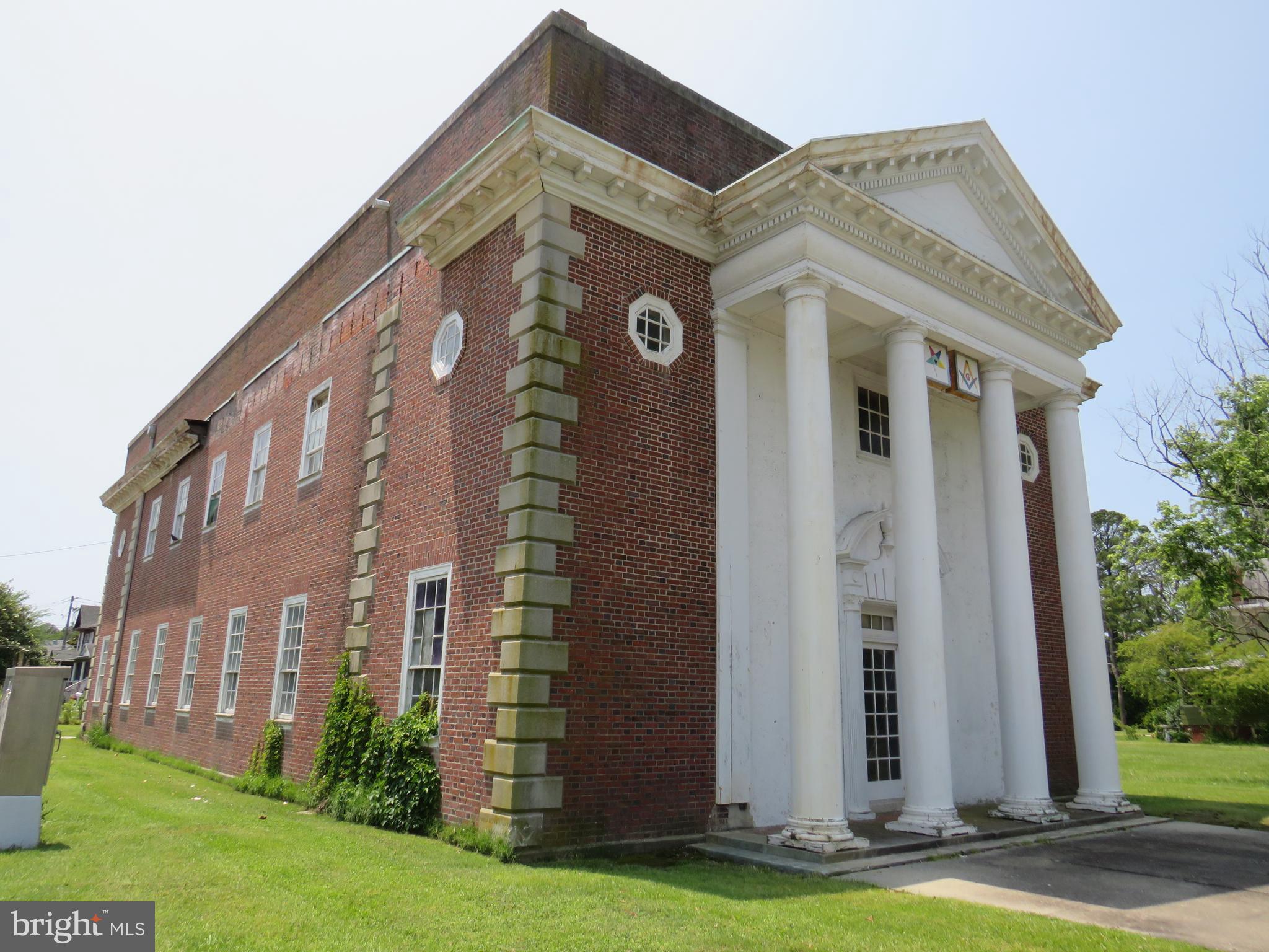 Historic Chesapeake Masonic Lodge located in Crisfield, MD. Once a booming seaport town, now its a quiet, small town with remainders of it's grand past. Beautiful building dates from 1920, all brick construction with grand architectural details. Meeting room on first floor boasts a wood coffered ceiling, small stage area and a large kitchen. Second floor meeting room has arched windows, intricate plaster detail on the wall and a painted coffered ceiling. There are several storage rooms, and two powder rooms. The roof is leaking, and there is water intrusion due to a missing cornice piece as well. There is plaster damage mainly on the front east corner of the building both upstairs and down. There is ceiling damage on the first floor due to plumbing leaks from ancient plumbing. The ancient boiler no longer works for the oil fired radiator heat. There is a lift for handicapped access to the second floor. It is indeed a diamond in the rough. There is a Maryland Historical Trust Easement on the property. Any prospective buyers should be aware of the implications. Please contact listing agent for details. All potential buyers must be prequalified, and proof provided. Listing agent must be present for showings.