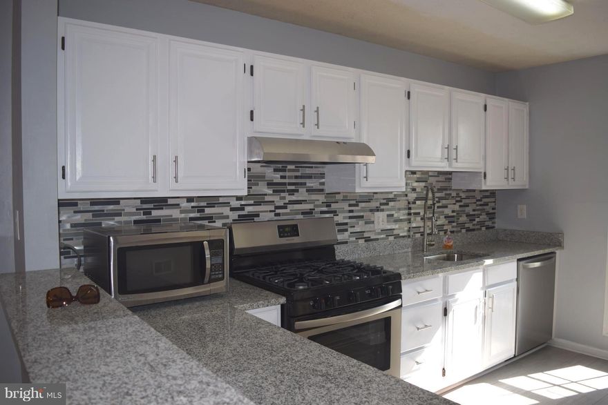 LIKE-NEW CONDITION--2 BR + den!  Den/sunroom opens to balcony overlooking expansive greenspace.1242 sf backs to lawn/trees. Modern open floor plan (wall removed between kitchen/dining rm). brand new appl., granite, new flooring, carpeting. Master w/ large walk-in closet. Fully renovated Bath.  Laundry rm w/ full size washer/dryer.  Owner open to longer-term rental, if initial lease pd works out.