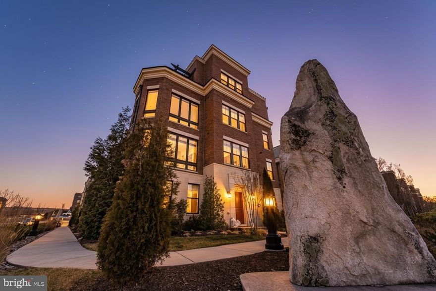 Perched on a premier front corner homesite, this exceptional end-unit townhome delivers a rare blend of privacy, luxury, and truly unforgettable views. From nearly every level, take in sweeping panoramas of the Potomac River, Wilson Bridge, National Harbor, and the iconic DC skyline—including the Washington Monument. By night, enjoy front-row views of dazzling fireworks displays from the comfort of your own home.

Designed with both elegance and functionality in mind, this 4-bedroom, 4.5-bath residence showcases thoughtful, high-end upgrades throughout. The gourmet kitchen serves as the heart of the home, featuring GE stainless steel appliances, a five-burner cooktop with 36” hood, double wall ovens, and an expansive 13-foot granite island—perfect for entertaining or everyday living. Custom cabinetry with pull-outs offers exceptional storage, while the open layout flows seamlessly into inviting living spaces anchored by a cozy fireplace.

Upgraded hardwood flooring, custom lighting, detailed molding, and designer tilework elevate every level. Each bathroom has been beautifully customized with premium finishes, including Ronbow vanities and refined tile selections.

The top-level retreat is an entertainer’s dream—complete with a spacious lounge, wet bar, and integrated SONOS sound system extending to the outdoor balcony. An indoor/outdoor fireplace creates the perfect setting for year-round enjoyment, whether hosting guests or unwinding with the skyline as your backdrop.

Additional highlights include remote-controlled shades, oversized 8-foot doors enhancing light and views, a two-car attached garage, and additional dedicated parking.

This is more than a home—it’s a front-row seat to one of the most stunning vistas in the region. Opportunities like this are rare—experience it in person.

Why this version will perform better: