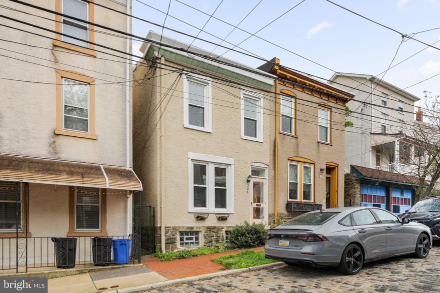 Situated on a quiet, cobblestone street at the peak of the Manayunk hills, 295 Hermitage Street is that rare find that strikes a perfect chord between traditional charm and contemporary upgrades. This bright and airy twin is bathed in natural light from its northeast-facing windows, highlighting gorgeous original hardwood floors that span the main and upper levels. The seamless flow between the generous living and dining areas leads you into a crisp, newly renovated kitchen featuring sleek white cabinetry, quartz countertops, and stainless steel appliances. Beyond the kitchen, you’ll find the highly coveted main-level laundry room and a convenient powder room. Step outside to discover an expansive, secluded rear yard... a private sanctuary with endless potential for al fresco dining, a solo stove lounge, or an epic garden! The side gate is a dream for cyclists and offers easy access for trash day. Upstairs, three comfortable bedrooms share a freshly renovated hall bath complete with modern white tile and sliding glass doors. With a tall-ceilinged basement ready for finishing and a location walkable to both the greenery of Gorgas Park and the energy of Main Street, this is an extraordinary opportunity to own a piece of the hill. 295 Hermitage Street is currently tenant occupied through August but can be delivered occupied or vacant to suit your needs.