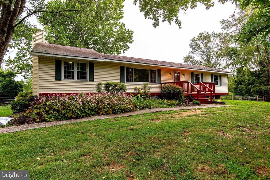 Horse owners you will not want to miss this amazing opportunity to own this rambler on over 2 acres. Lot is mostly fenced for horses with 2 stall barn and fenced area for chickens as well as a great garden area. Oversized rambler has 3 beds and 2 full baths on main level as well as large kitchen, dining and living room. Walk out from main level to large deck perfect for entertaining. Finished walk out lower level with large family room, gas fireplace,  bonus room and full bath. All new hard flooring on main level. Quiet neighborhood with plenty of parking for all of your vehicles or trailers. NO HOA. Home is being sold AS IS and needs some updating. Come fall in love!