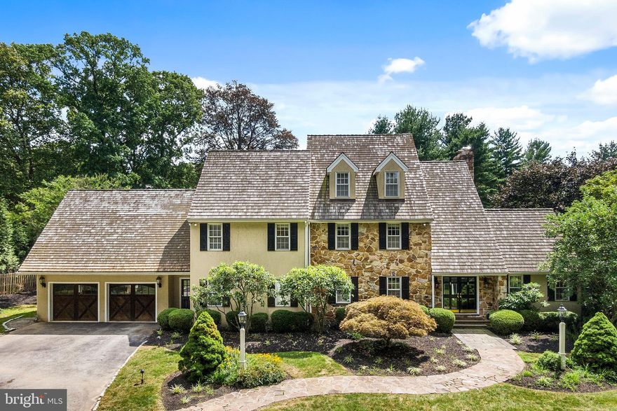 Nestled in the sought-after estate section of Bryn Mawr on a sprawling, park-like lot, this PA blue stone front classic Colonial home exudes sophistication and convenience at every turn. Enter through the custom double glass doors into the light-filled, two-story foyer featuring direct sightlines to the backyard patio and in-ground pool. Boasting wide-plank hardwood floors, high-end finishes and custom millwork throughout, the expansive first floor is designed for casual family living and effortless entertaining. Just off the foyer you?ll find a well-sized living room that connects to a family room with wood-burning fireplace and triple sliding glass doors leading to the back patio. Along with scenic backyard views, the well- appointed chef's kitchen boasts a large center island with seating for four, a double wall oven, Sub-Zero refrigerator, farmhouse sink and built-in microwave with warming drawer and a seating area for two; a perfect spot to catch up on emails or to sit for morning coffee.  A convenient wet bar with elegant glass shelving, sink and ice machine connects the kitchen to the extra-large formal dining room, which features hand painted walls to look like grass cloth, millwork, recessed lighting and a walk-in china closet. A home office/den with custom built-ins and a spacious mudroom with four large closets and direct access to the attached oversize two-car garage complete this stunning first floor. The second floor includes a large laundry room and three generously sized bedrooms, including a master suite with his and her custom closets, walk-in shower and soaking tub with oversized picture window. All bedrooms have their own bathrooms.  A set of hallway stairs leads to a freshly painted, newly carpeted third floor suite with bedroom, full bathroom and bonus room perfect for a home office or gym. Featuring an open floorplan and ample storage space, the fully finished basement offers even more space for relaxation and family fun. The fenced-in, beautifully landscaped backyard with southern exposure is sure to inspire countless staycations with its in-ground pool and built-in spa with PA blue stone retaining wall and separate side yard for sports and play. Recent improvements include conversion from oil to gas and installation of new heating system. Freshly painted throughout, new carpets and clean recent stucco test available online.  Located on one of the most desirable streets in Bryn Mawr in the award-winning Lower Merion School District and just minutes from the Main Line's top shopping, entertainment and dining spots. This well-maintained, move-in ready home awaits your personal touch.  Schedule an appointment today!