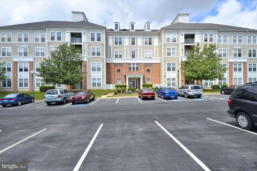 Rare-to-market, sun-filled, remodeled 3BR/2FB CORNER condo in a pet-friendly, elevator building with panoramic views from three sides.  Open floorplan with approximately 1375 sq. ft. of area plus an oversized covered balcony facing a courtyard as well as a one-car detached garage. Special features include: 9-foot ceilings; new custom painting; crown molding; bamboo hardwood flooring; new stamped pattern carpeting in all of the bedrooms; granite and stainless kitchen; updated baths with new vanity lights, upgraded ceramic tile, and new glass enclosures; new lighting fixtures and recessed lighting throughout; marble gas fireplace with built-in bookcase; multiple closets and private storage room in the building.  Tons of natural light streams into this unit with its Southern and Western exposures.  Foyer entrance with new lighting, double-door coat closet, second closet, and walk-in HVAC/storage closet with storage shelving; living room features a gas fireplace with wood mantel, marble surround, built-in cabinetry, and recessed lighting; dining room with double window and chandelier; gourmet kitchen with 42-inch white cabinets with under cabinet lighting, granite countertops, insta-hot faucet, breakfast bar, and Whirlpool stainless steel appliances; outdoor space accessed from sliding glass doors to an oversized private covered balcony facing a peaceful courtyard; primary bedroom suite with new lighting, walk-in closet, and second closet; master bath with ceramic tile flooring, new vanity light, walk-in shower with designer tile, listello border, and new glass enclosure, and linen closet; second bedroom with walk-in closet fitted with multiple levels of ventilated shelving; third bedroom with new lighting and walk-in closet; second full bath with ceramic tile flooring and designer tile tub surround, new vanity lighting, and new glass tub enclosure; hallway with laundry center equipped with full-sized washer & dryer; separately deeded one-car garage with garage door opener and keypad; private storage unit (#4-6) on fourth floor of building; water-source heat pump air handler & compressor (2018) that uses gas hot water as well as electric to heat your home; gas hot water heater (2012).  Right in the heart of everything that King Farm has to offer...only a few blocks to the community pool, multiple parks, tennis courts, and fields, the King Farm Village Center shopping, and nearby courtesy King Farm shuttle stop to Shady Grove Metro.