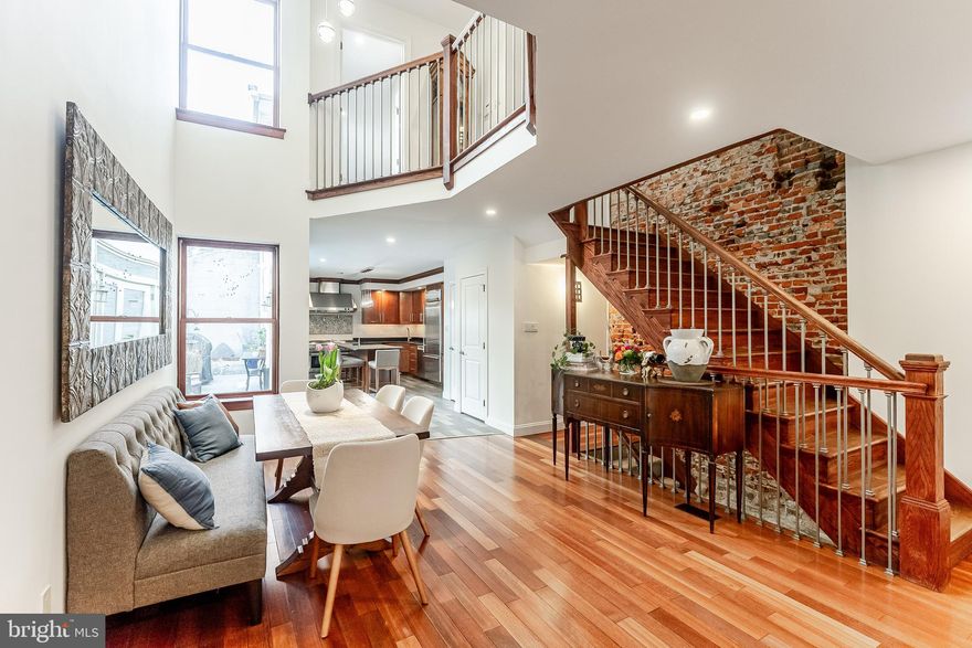 Incredible New Listing in the heart of Queen Village, Meredith School Catchment. Welcome to 113 Kenilworth St. This open-concept marvel boasts an impressive 3,600 square feet and is situated on a 20x65 foot lot. Featuring four generously sized bedrooms, three and a half luxurious baths,  den/family room, 3 private decks, a side garden and a finished lower level.
As you enter, you are welcomed by a sizable foyer that seamlessly flows into the inviting extra wide living room, which is anchored by a charming fireplace, adorned with soaring ceilings, and graced with beautiful hardwood floors. The transition into the two-story dining room is nothing short of spectacular; it is bright and spacious, ideal for hosting family holiday dinners and celebrations. This area effortlessly leads to the dream kitchen, complete with a generous island workspace, commercial-grade appliances, ample counter and cabinet space, and a large butler's pantry. The kitchen's wall of atrium doors opens to a tranquil and inviting outdoor garden space, perfect for relaxation and entertainment. Additionally, a separate storage shed is conveniently located just behind this serene area. 
The home's design features a gracefully crafted extra-wide custom staircase, accentuated by a stunning exposed brick wall, which creates an inviting ambiance, particularly when adorned with tea light candles.  
On the second floor, the hall area is bright and spacious, leading to a beautifully appointed rear en-suite bedroom that includes a full bath and well-organized closets. This level also houses another generous bedroom overlooking tree lined Kenilworth St. with a spa-like bathroom, and a separate laundry room equipped with a utility sink for added convenience. 
Ascending to the third floor, the master suite occupies the entire level and is truly a haven of luxury. The rear bedroom, currently utilized as an office, features sliding glass doors that open onto a private deck, along with an additional deck accessible from the hall area. The front main bedroom is introduced via elegant double doors and includes a lavish spa bath with a double vanity, a separate steam shower, and a rejuvenating Jacuzzi tub. A spacious walk-in closet enhances the suite's functionality, while a staircase leads to a delightful private sitting or den area, which also offers sliding glass doors to another sizable deck. 
The basement is a vast, finished space with high ceilings and currently serves as a family/media room. It features three restored stone-arched alcoves, perfect for the discerning wine connoisseur’s wine cellar. Additionally, there is a separate room providing substantial storage and housing the home's mechanical systems. 
Nestled on one of Queen Village's most desirable tree-lined blocks, this lovely home is complemented by a full year of pre-paid parking at the nearby Queen Village parking lot. It boasts not only great neighbors but also convenient access to everything you could possibly desire, all within the esteemed Meredith catchment area.  
This stunning property is not merely a home; it is a sanctuary of comfort and elegance, awaiting its next fortunate owner.