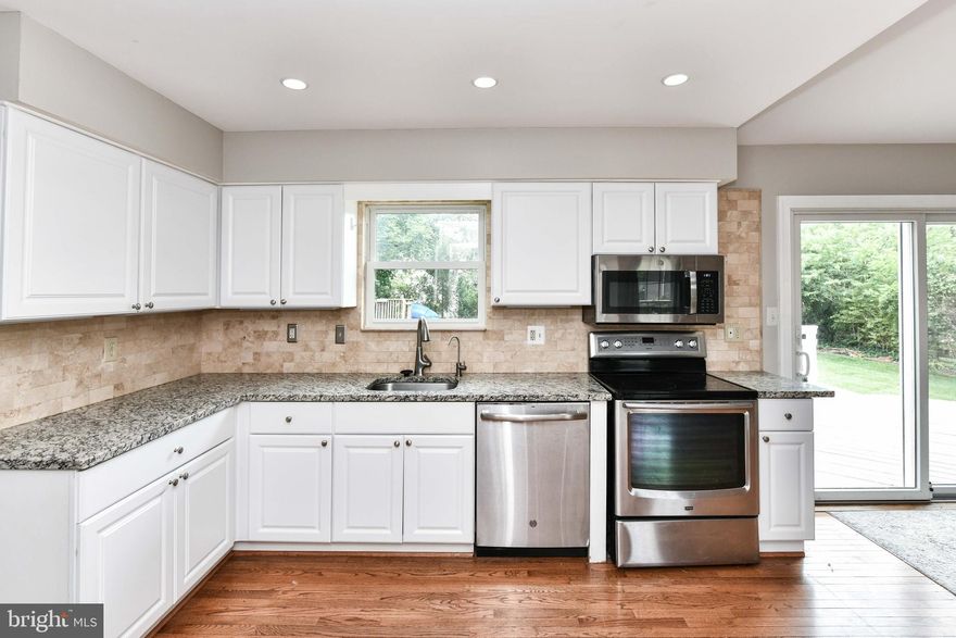 Renovated 3BR, 2.5BA, 1-car garage home with charming curb appeal featuring flagstone walkway & porch*Main level features crown molding & light grey paint tones*Inviting living room features custom built-ins surrounding decorative-only white brick hearth fireplace*Remodeled Kitchen features hardwood floors, granite counters with complimentary travertine backsplash, recessed lights, ample white cabinetry with under cabinet lighting & stainless steel appliances*Dining area off kitchen features 42" grey cabinets with designer backsplash & sliding glass doors leading to deck*Formal dining room off kitchen nook with chair rail*Primary suite features custom shelving in closet & en suite updated bathroom featuring granite vanity & tiled shower*Two additional nicely sized bedrooms share second full bathroom*Finished Lower Level features rec room with custom built ins, den & laundry room+ storage*Fantastic level, fenced backyard with oversized deck*Prime Location, center of town! Nestled in the Great Falls Forrest community, where every street adjoins quiet cul-de-sacs & walking trails*Great location - close to Algonkian Park & the popular Horsepen Run Nature Preserve*Easy access to route 7, Route 28, Dulles Toll Road & Dulles Airport!