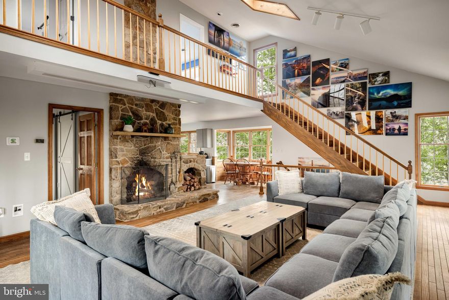 Light-filled, open cabin with a large stone wood-burning fireplace, screened-in porch, and brand new hot tub – tucked away in the sought-after Coolfont community, and just 10 minutes from downtown Berkeley Springs & Cacapon State Park!  The cabin boasts 4 large bedrooms, 3 bathrooms, a modern kitchen with an island, large living room for entertaining, central heat & AC, and fast wireless Internet.  The Coolfont community has a summer pool and hot tub, as well as miles of hiking trails.  Whether as a full-time residence or vacation rental, this is a rare find in one of West Virginia’s premier mountain destinations. As a vacation rental it has generated $91,000 over the past 16 months, and can come with an existing property manager and cleaner. Hot tub and furniture optional, available for purchase.  See seller docs for a summary of rental history and financials.  $1,000 buyer credit if you continue using the same property manager.  Perfect primary residence or vacation home!