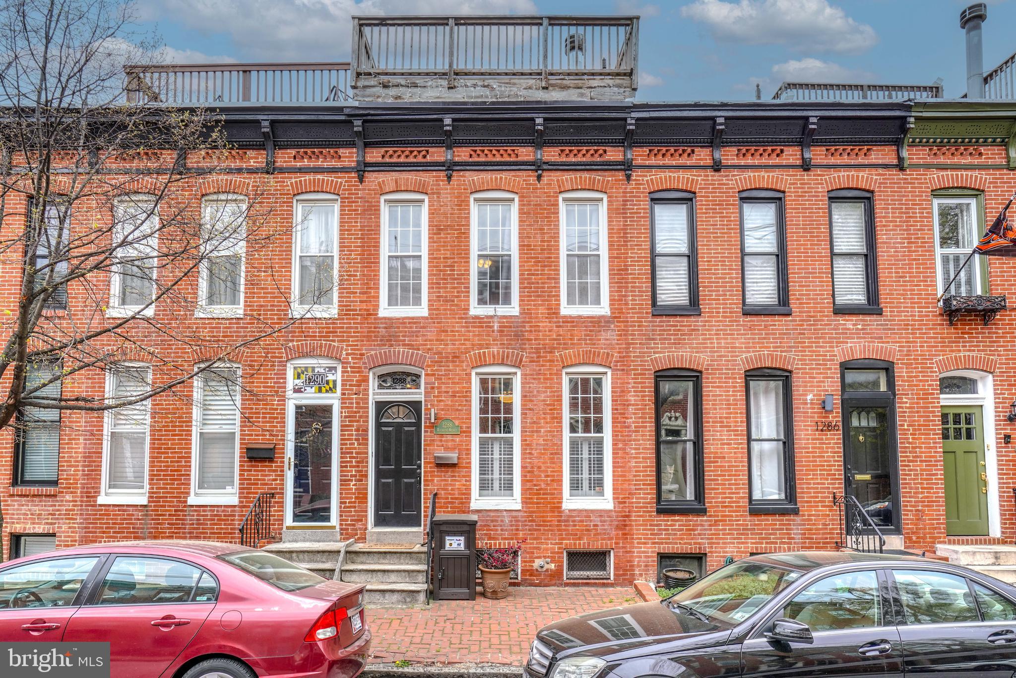 Discover the charm and modern convenience at 1288 Riverside Ave., a beautifully appointed residence blending historical elements like wood floors, exposed brick, and a unique tin ceiling in the kitchen with contemporary comforts. The center of the home is the kitchen, with granite countertops and stainless appliances, complemented by a breakfast bar. The layout on the first floor includes separate living and dining rooms, a convenient powder room, and a laundry area, making everyday living and entertaining a breeze. Upstairs, enjoy privacy and comfort with two spacious bedrooms, and 2 full bathroom. Additional perks of this home include a private parking pad and a spectacular rooftop deck offering panoramic city skyline views, perfect for relaxing or hosting gatherings. Situated in the heart of Federal Hill, 1288 Riverside Ave. offers an ideal blend of style, function, and luxury, making it an outstanding choice for your next home.
