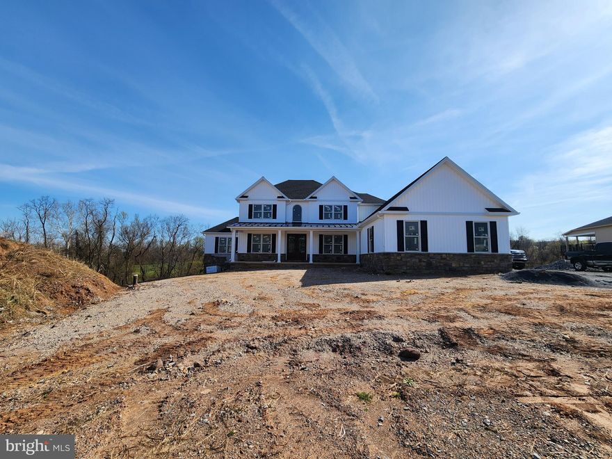 Exceptional home showcasing an open floor plan designed for both everyday living and entertainment. Highlights include a spacious first-floor primary suite, a two-story great room, wide plank white oak flooring,  ceramic tile floors  and quality finishes throughout. The custom kitchen is the heart of the home, featuring a 10 foot island, granite countertops, ceramic tile backsplash (still time to select your choice), under cabinet lighting, a walk-in pantry, gas cooktop and double oven. If you would like, the island easily accommodates casual dining, allowing the adjacent breakfast nook to function as a bright and inviting four season space. The kitchen flows seamlessly into the two-story great room, filled with natural light and anchored by a stone fireplace, and is also open to the formal dining area. The spacious first-floor primary suite offers a 10-foot tray ceiling, a walk-in closet with custom shelving, and an ensuite bath complete with a zero-threshold ceramic tile shower, heated tile flooring, and a double-bowl granite vanity. On the second level, you’ll find three generously sized bedrooms, two full baths, and a cozy loft area. The largest bedroom functions perfectly as a second primary suite, featuring its own private bath and walk-in closet. An exposed walkout basement with rough in plumbing for a full bath, allows room to expand if needed. JW Mumper is the builder. This home sits on a 1.53 acre lot and backs up to mature trees providing privacy and the small spring feed stream borders the rear of the property.  Additional features include: 400-amp electric service, engineered white oak hardwood flooring, solid core interior doors,  Andersen 200 Series double-hung windows, Decora rocker switches, LED lighting, Schlage locksets, insulated interior bathroom and laundry room walls, 9-foot  and 18-foot ceilings on the first floor, 9-foot poured concrete basement walls  oversized side-entry 3-car garage with insulated doors and openers, covered front porch, 16x25 composite deck with views, multi-zone heating, dual HVAC system (electric heat pump with propane backup), owned propane tank, tankless water heater, main-level laundry, tray ceilings, cathedral ceilings, crown molding, chair rail, large walk-in attic storage area, and more. Oak Hill is a custom home community tucked away but less than 20 minutes from UPMC and PSU Medical Centers  and minutes away from Liberty Forge Golf Course, Lower Allen Park, Roof Park, Ski Roundtop, Gifford Pinchot State Park and the scenic Yellow Breeches Creek .  The location also allows for easy access to  I-83, PA Turnpike and Route 15.   Additional community information can be found by clicking the BRIGHT- Documents icon.