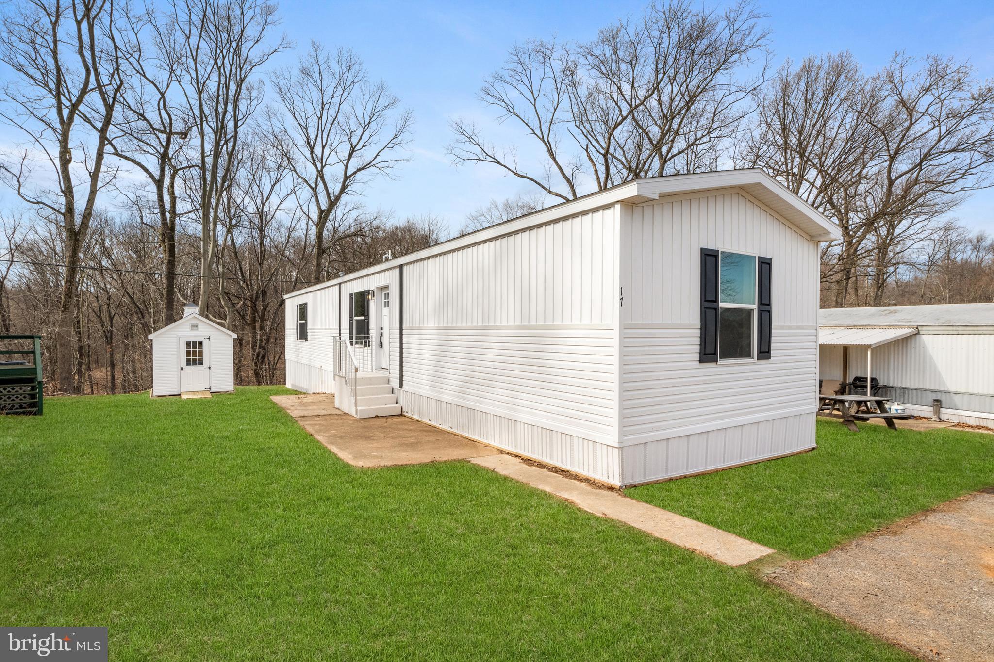 ***Seller bought this home directly from the manufacturer at dealer cost. Home is being sold below cost in an effort to fill the empty lots in the mobile home community.
Welcome to your brand new mobile home in the Margaretta MHP Community! Nestled in a beautiful and secluded location within the Eastern York School District, this home offers both privacy and convenience. As you step through the front door, you'll be greeted by an open layout that creates a spacious and inviting atmosphere. The kitchen boasts tons of cabinet space, tastefully designed to accommodate all your cooking needs. The living room features an accent wall, adding a touch of charm to the space. With 3 bedrooms and 2 bathrooms, there's plenty of room to relax and unwind. Plus, washer dryer hookups make laundry day a breeze. This home is E Built, which means it is 30-50% more energy efficient then other manufactured homes. Insulation, Energy Star appliances, specialized water heater and windows all contribute to its energy efficiency. This home is also Zero Energy Ready which means it can be connected to solar or wind easily. Outside, you'll find a brand new 8x10' Stoltzfus A Frame Shed with Cupola included with the home, providing ample space for all your storage needs. One year limited home warranty included with the sale. Don't miss out on the opportunity to make this beautiful mobile home yours. Call today to schedule a tour! ***Each home has two parking spaces available.***