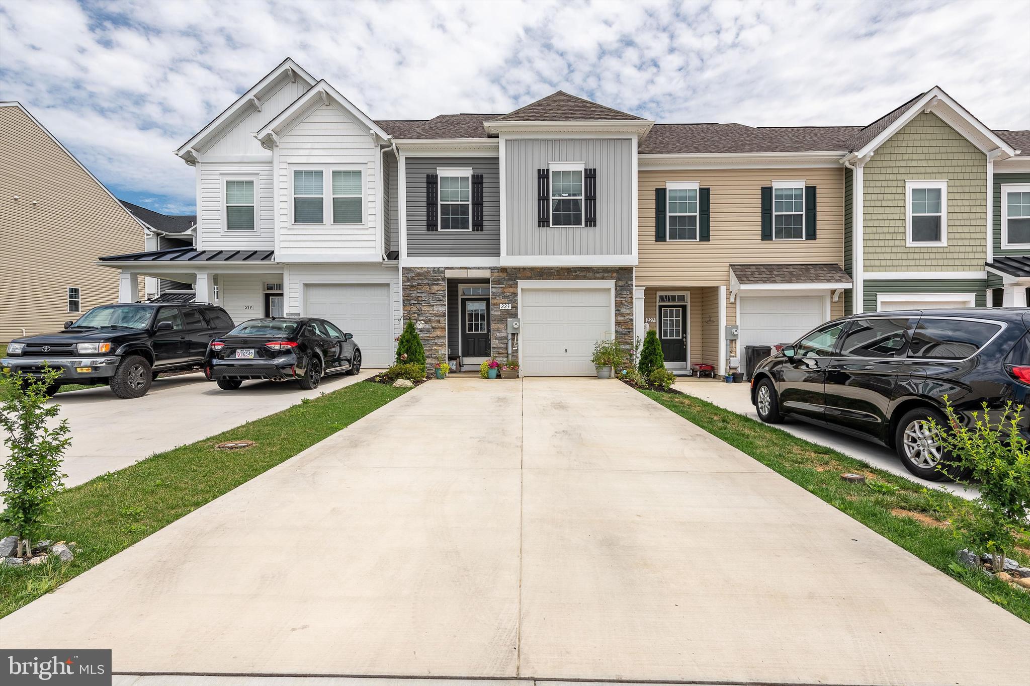 This fantastic designed townhome is almost better than new! Seller has added nice extra touches that won't leave you disappointed. Only one year new! Newly added wooden batten wall in entry way. Blinds are upgraded throughout. Very well designed cabinets and quartz counters. All stainless appliances convey. Owners suite features a large walk in closet, double vanity bath with separate tub and shower stall. Laundry is up on 2nd level making doing laundry a breeze. OVERSIZED concrete driveway allows multiple vehicles. Nice backyard patio. Community offers very nice amenities for all....large play ground. dog park, walking areas. Don't need to worry on lawn maintenance - HOA covers that for you!! Public Open House this Thursday 6/29 from 4-6pm!