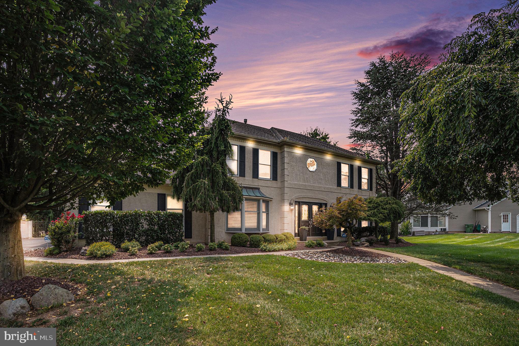 New on Market! This stunning charmer is open, bright, and airy, offering 5 bedrooms, 2 full baths, and 2 powder rooms, with approximately 3,500 sq. ft. of living space including a wonderful finished basement with powder room—all in meticulous condition. Located in the sought-after Dublin Hunt community, just steps away from Starbucks, Sprouts Market, HomeGoods, great dining spots, and more, this home is the perfect blend of comfort and convenience. Set on a beautifully landscaped lot framed by trees, the property features a private gated pool and spa with lantern lighting—an entertainer’s dream! The built-in outdoor bar and dining area with electric awning make it ideal for gatherings with family and friends.
The home’s incredible curb appeal is enhanced by a double-door entry with sidelights leading into a dramatic two-story foyer with turned staircase, elegant chandelier, tile, and hardwood floors throughout the main level. The heart of the home is the white gourmet island kitchen, boasting quartz countertops, stainless steel Sub-Zero refrigerator, stainless steel ovens with commercial range hood, two warming drawers, built-in microwave, wine rack, wine/coffee bar, and two pantry closets. A bumped-out breakfast room with skylights, electric window shades, and plantation shutters in many other rooms provides a bright and welcoming space with direct access to the outdoor dining area—perfect for morning coffee or summer BBQs. The second floor is as beautiful as the first floor. Double door entry into the stunning main bedroom suite with a totally refurbished bathroom, a great walk in closet , plus an additional built in closet. There are three other spacious bedrooms and a refurbished hall bath. Additional highlights include: LED recessed lighting throughout this stunning home with under-cabinet ambient lighting in the kitchen. The gourmet kitchen is open to the living room and family room. There is a striking floor-to-ceiling stone gas fireplace. The fifth bedroom/guest room is on the main level and the beautiful powder room and laundry room completes the first floor. The finished basement with powder room—perfect for a gym, media room, office, or playroom. This home truly has it all—modern upgrades, timeless charm, and spaces designed for both relaxation and entertaining. All within the award-winning Upper Dublin Township School District—one of the top-rated in the area