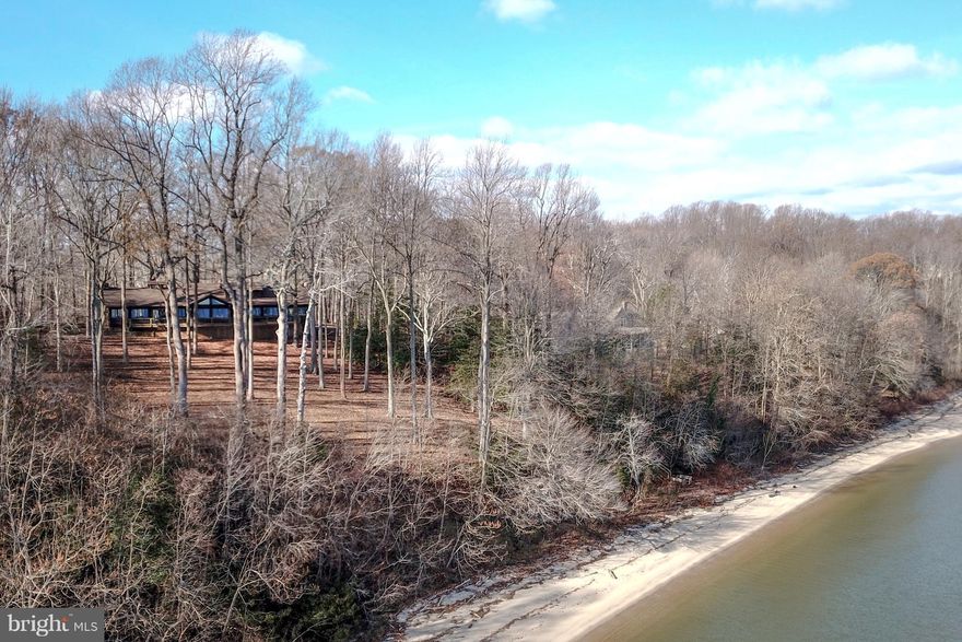 ONE OF A KIND SERENE RETREAT.  NATURAL CHESAPEAKE BAY BEAUTY IN ALL SEASONS.  SITTING HIGH ABOVE ITS PRIVATE BEACH.  RARELY AVAIL POST & BEAM STRUCTURE CA.1915 CAMP ROOSEVELT LODGE, A NON-RIPARIAN WATERFRONT PROP RESTS ON 1.8 ACRES - SWEEPING VIEWS OF CHES BAY COMBINED W/ A BROAD SANDY BEACH.  4800SF ROUGH HEWN CEDAR SHIPLAP ADIRONDACK STYLE HOME, W. SOARING BEAMED CEILINGS & MASSIVE STONE FIREPLACES BLENDS MODERN LUXURIES OF TODAY WITH MEMORIES OF CAMP LIFE.  ONLY 40 MINS TO DC OR  ANNAPOLIS.  AVOID THE BRIDGE!