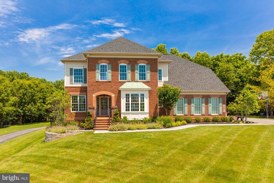 The premier lot in Robert's Landing holds over an acre of pristine landscaped grounds that feature flagstone terraces and a fountained pool that will cool your summer days and an outdoor gas fireplace to warm your cool nights.   Five bedrooms, four and one-half baths, a gourmet island kitchen with granite tops and Kitchen Aid appliances, a family room with coffered ceiling and gas fireplace, a master suite with a newly renovated master bath, a main level office, a lower level family room, kitchenette and gym and an outdoor, built-in barbeque grill.  A two-car, side-load attached garage completes this American dream. Features:   Main Level Hardwood Floors; 2 Zone Central Air Conditioning; In-ground irrigation system; All new carpeting on stairwells, upper and lower levels; Completely refurbished kitchen and bath cabinetry; 5 Burner Cooktop; Kitchen Aid Double Wall Ovens; Family Room with gas fireplace; Lower Level au pair/in-law suite; Lower Level Gym; In-ground pool with automatic cover and fountains; Outdoor gas fireplace; Lavish flagstone terraces; Landscaped, fully fenced rear yard with mature plantings & lighting.