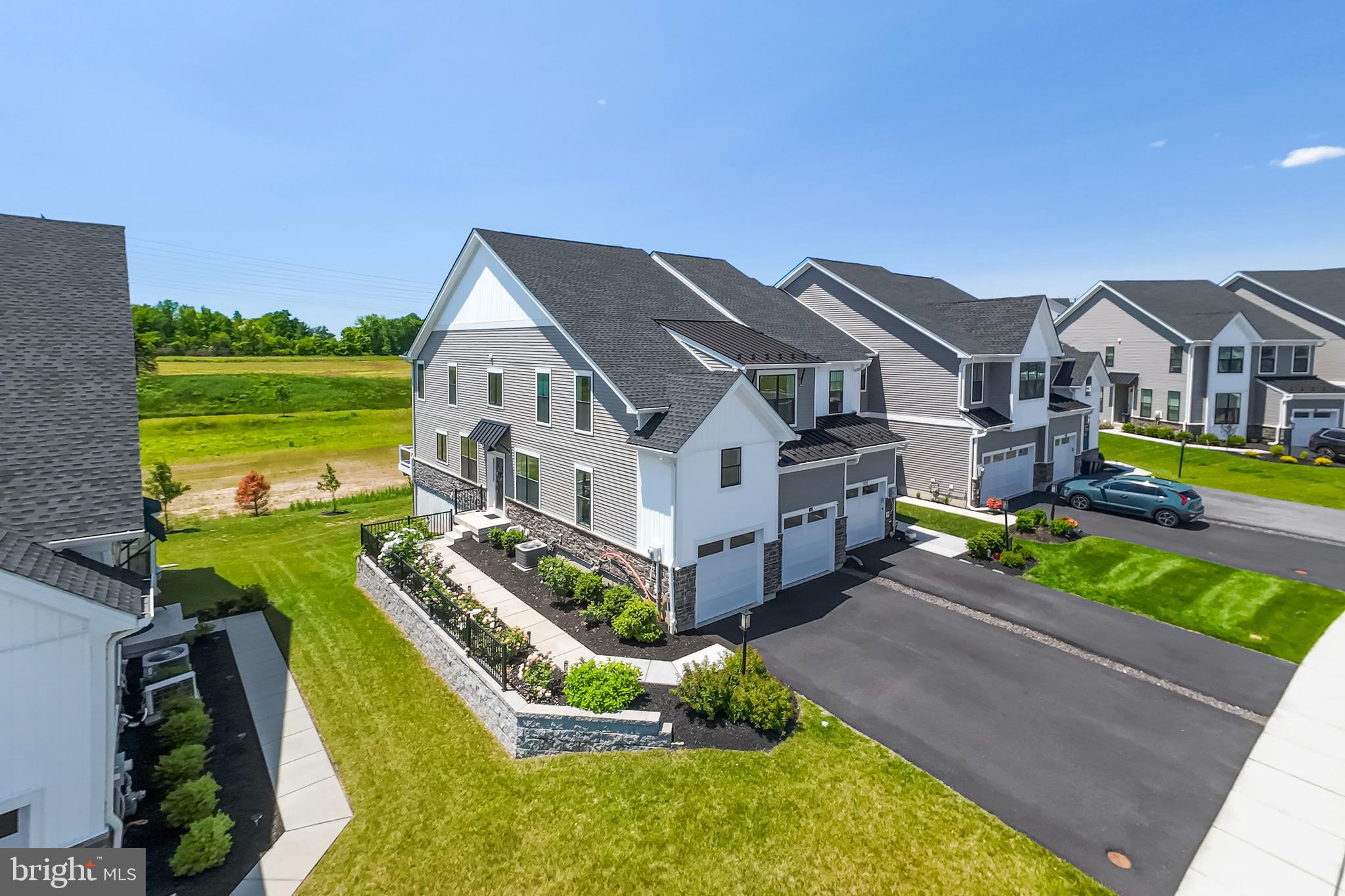 Located in the highly regarded Methacton School District, this Toll Brothers end-unit townhome combines upscale finishes with thoughtful design and functional living spaces. Built in 2022, the home features a finished walk-out basement, a composite deck overlooking open green space, and an ideal layout for modern lifestyles.
This 3-bedroom, 2.5-bath home offers beautiful hardwood floors throughout the main level, a finished walk-out basement, and a composite deck overlooking serene open space. Curb appeal abounds with vertical white siding, a stately stone façade, neutral exterior tones, and a spacious two-car garage.
Step inside through the covered entryway, past a decorative wrought iron barrier, and into a bright, open-concept main level. The living room and kitchen flow seamlessly together, creating a spacious and inviting area for everyday living and entertaining. The kitchen features white cabinetry, quartz countertops, stainless steel appliances, and gold-accented pendant lighting. Four oversized windows flood the space with natural light, and the adjacent deck offers tranquil views of open green space.
Next to the dining area, you'll find a versatile flex room—perfect for a home office, playroom, or study.
Upstairs, the spacious primary suite boasts a tray ceiling, recessed lighting, a luxurious marble-floor ensuite bath with soaking tub and separate shower, and a generous walk-in closet. Two additional bedrooms provide flexibility for guests, children, or additional office space, along with a full hall bath.
The finished walk-out basement offers endless possibilities—ideal for a media room, home gym, or entertaining space—plus ample unfinished storage.
Additional highlights include a two-car garage, an extra-wide driveway, and convenient access to Routes 202, 73, 476, and the PA Turnpike. Enjoy proximity to top shopping, dining, and entertainment options.
Don’t miss your opportunity to own this move-in-ready gem—schedule your private tour of 65 Tamarack Circle today!