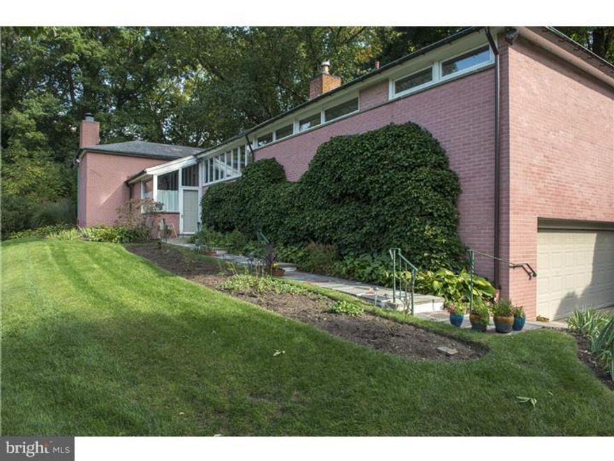 Where Ozzie & Harriett meet Mad Men is how I would best describe this mid-century raised ranch home in the heart of Wyncote! I can just imagine Don Draper enjoying a cocktail in the open-plan living/dining room with a wall of windows overlooking the rear yard. This property has been in the same family since the late 1950's and it is an immaculately maintained time capsule from another era. Located on a quiet side street, yet within easy walking distance to the Jenkintown/Wyncote train station (with the best scheduled service to downtown Philadelphia of any suburban station, and also direct access on the Airport line), the house sits proud on it's nearly   acre parcel.  A large 2-car garage is tucked into the basement level, and a flagstone pathway leads up to the front door.  A lovely salmon-colored brick surrounds all 4 sides of the house.  One enters into a sunny atrium foyer (with a cool planter bed and a wall of windows!) and up 5 slate steps to the main living level.  All of the bedrooms and the laundry are located on this main floor.  The entire rear of the home is the living/dining room (36' x 15') with taller ceilings and a wall of windows looking out over the rear yard.  A functioning greenhouse is accessed through the living area and is half the width of the house. A rear patio (with a pergola) is accessed through the dining area and there is a large storage shed tucked at the rear of the property. The kitchen was updated in the 1980's and the laundry was moved up from the basement at that time as well. It's a fully functional space with ample storage and direct access to the side yard.  The bedroom wing is accessed via a paneled hallway (vintage cool) with an entire wall of clerestory windows (for light, yet providing privacy).  The master suite is at the end, and has its own en-suite bathroom and two large closets.  Two more bedrooms and a hall bathroom complete the main floor. Downstairs, the basement has the family room, a home office and the powder room. There is access to the side yard from the basement, and then access to the garage as well. The house is serviced by a gas-fired HVA/C system and central air is also throughout the home. One might want to update the house, but it's so vintage/retro that one could be just as happy to keep all the original mid-century details and share Martinis with friends in front of the fireplace! 1 year HSA Warranty included with the sale.
