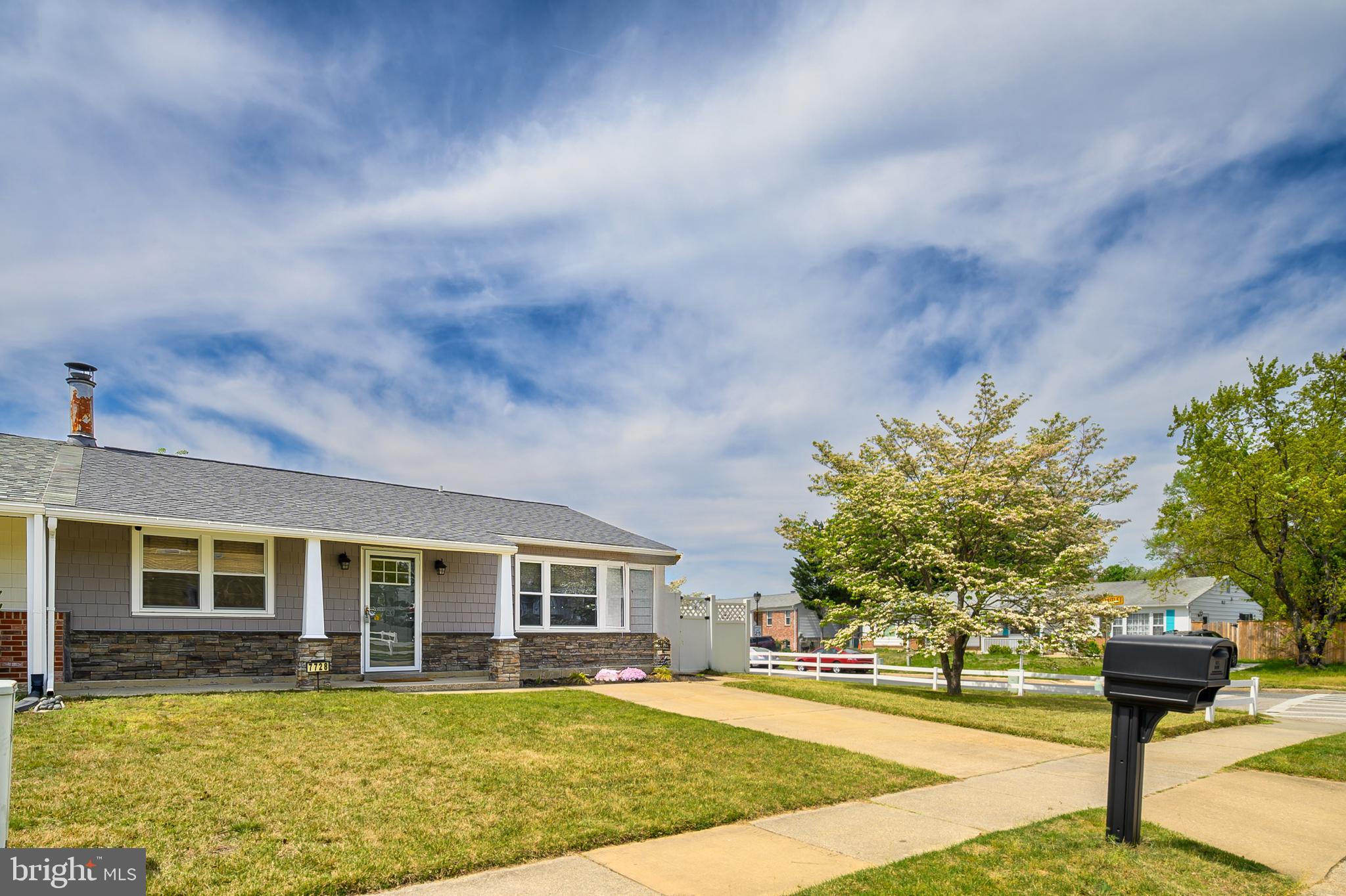 Renovated one level living duplex with an oversized detached 2 car garage! This gorgeous rancher was beautifully updated in 2021 with new siding, formed stone exterior, new front door, new roof (2020), new HVAC (2017), Kitchen and bathroom new in 2017. Durable laminate flooring throughout. The kitchen features 42" cabinetry with wine storage, quartz countertops, subway tile backsplash, updated appliances including concealed, space saving stackable new washer and dryer (2023). Enjoy cold winter nights by the wood burning fireplace. The full bath has classic, yet stylish appeal with the tile choices, including tiled shower surround, white vanity with solid surface top, and tiled floor. The oversized garage is a huge bonus space for storage, workshop, etc. The corner lot provides two driveways giving ample parking for homeowner's and guests. The partially covered deck gives additional outdoor entertaining space.