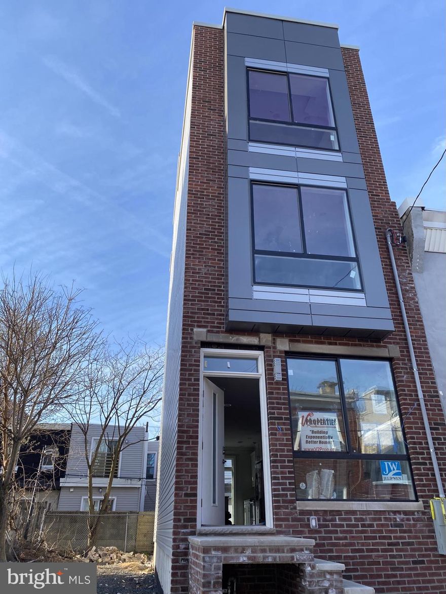 1,970 sq. ft. new construction home with approved 10-year tax abatement. Built by V2 Properties, Philadelphia s Premier Home Builder. Some spectacular features include a rooftop deck with wet bar on the landing, rear yard, granite kitchen, hardwood floors throughout, great technology and more. Wide trim package through home, elegantly tiled baths, a full 3rd floor master suite spacious closets, and private spa-inspired bathroom. This home also has a finished lower level with tile flooring perfect for a 4th bedroom or 2nd living room. The front facade is brick with a designer standing seam metal sided accent panels and iron railing. The exquisite kitchen which has beautiful cabinets, granite counters, granite island with pendant lighting above, a tile backsplash and quality stainless steel appliances! All of the bathroom vanity counter-tops are granite or quartz. The master bedroom includes a trey ceiling with crown molding illuminated with accent lighting. Tech includes: built in speakers, video doorbell, nest thermostat, alarm system, and full home automation compatibility. Top quality new construction home at a very reasonable price, built by the city's premier home builder! Super low taxes. Also, Builder warranty included by a builder with proven reputation of standing behind their warranty!!