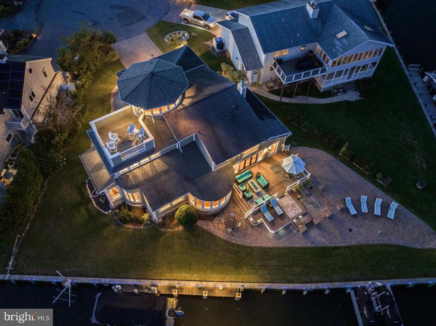 Luxurious Bayfront Residence in Ocean Pines with
Panoramic Views Key Highlights: Stunning Vistas: Step inside and be immediately
captivated by the unobstructed bay views and the mesmerizing Ocean City skyline. Every
room offers a dynamic panorama, ensuring a scenic experience like no other. Exclusive
Point Lot: Nestled in one of the 13 distinguished point lots in Ocean Pines, this gem
guarantees an unmatched waterfront lifestyle. California Dreaming: Evoking the spirit of the
West Coast, this contemporary California-inspired architecture seamlessly blends luxury
with comfort. Entertainer’s Dream: Equipped for both indoor and alfresco gatherings, this
residence ensures memorable moments against a backdrop of water and sky. Auditory
Elegance: A state-of-the-art surround sound system pervades every corner of the
residence, from its interior spaces to the lower and upper decks, setting the perfect
ambiance for every occasion. Chef’s Delight: Revel in the gourmet kitchen that overlooks
the serene bay, complete with premium granite countertops, custom cabinetry, a state-ofthe-art Viking stove, and gleaming stainless-steel appliances. Elegance Throughout:
Whether it’s the formal living room or the dedicated dining space, every inch of this house
spells sophistication. Relaxed Revelry: The expansive family room, equipped with a sleek
wet bar, seamlessly flows into a meticulously designed hardscape patio. Optimized
Comfort: Experience the luxury of a brand new HVAC system (2022) dedicated to the upper
floor, ensuring year-round comfort in every corner of the residence. Versatile Living:
Boasting 4 plush bedrooms and 3.5 lavish baths. Dual master suites on both the first and
second levels cater to a versatile living experience. Turret's Charm: The unique third-floor
turret, or Widow’s Watch, provides an elevated view of the bay, complete with a private
outdoor deck to immerse in the beauty of the surroundings. Waterfront Wonderland: A vast
200+/- Ft of Bulkhead lays the canvas for any aquatic adventure. Safeguard your prized boat
on the 12,500 lb lift and take advantage of the expansive dock, dedicated Jet ski lift, and a
brand new third jet lift introduced in 2023. Enjoy all the amenities of Ocean Pines: an
oceanfront beach club with parking on 50th street in Ocean City, a public Yacht Club in
Ocean Pines, five pools, two marinas, a premier racquet sports complex, and a Robert Trent
Jones Sr. -designed championship golf course. Discover unparalleled luxury combined with
an idyllic waterfront setting. A visit is essential to truly appreciate the essence and charm of this exceptional home.