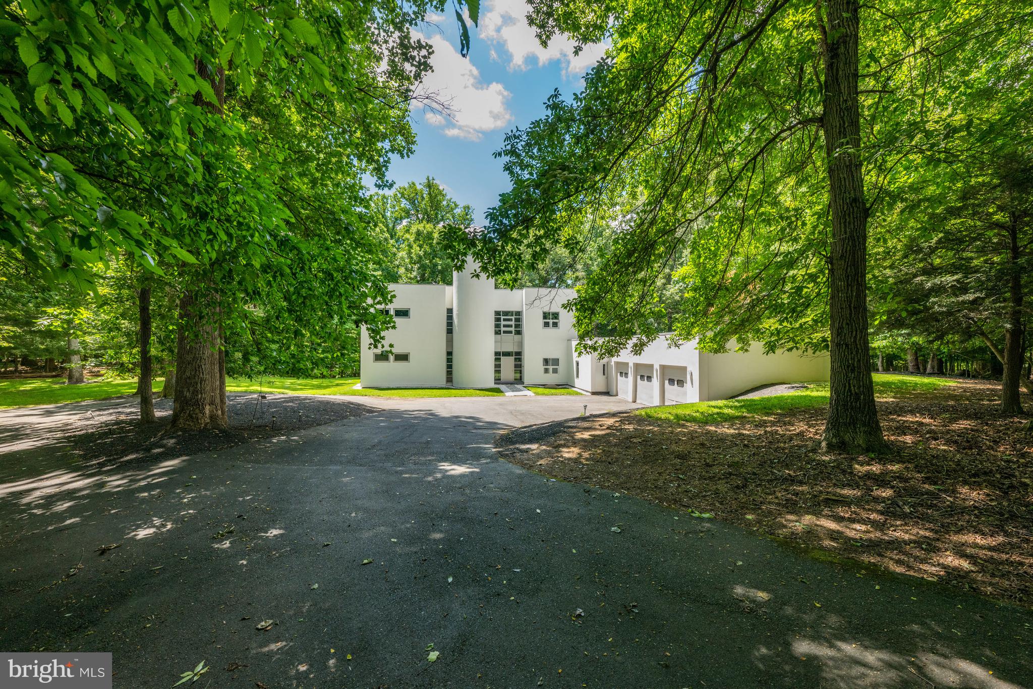 Showing Hours: Weekdays: 11:00 AM - 2:45 PM. Weekends: 11:00 AM - 4:00 PM. Welcome to this renovated contemporary home filled with light and elegant finishes. An exciting interior circular staircase and gorgeous skylights are focal points of the residence. Beautiful hardwood floors, designer windows and doors, and an artfully designed contemporary floor plan await you, along with a large level lot with swimming pool to keep you cool on warm summer days. The main level of the home offers a high ceilinged double living room with fireplace, a formal dining room, a gourmet kitchen with every bell and whistle imaginable along with a breakfast room for informal dining. This main level also provides two main level bedrooms each with their own ensuite bath. A three car garage completes this main level with ample parking for three cars plus another six or more in the driveway area. Upstairs the primary bedroom with more than ample closet space and an elegant primary bath provide a quiet retreat. Two additional spacious bedrooms with ensuite baths complete this upper level of the home. Contemporary design, elegant finishes and a quiet retreat await you in this recently renovated residence. Five minutes away from the village of Potomac with the best of shopping and restaurants.