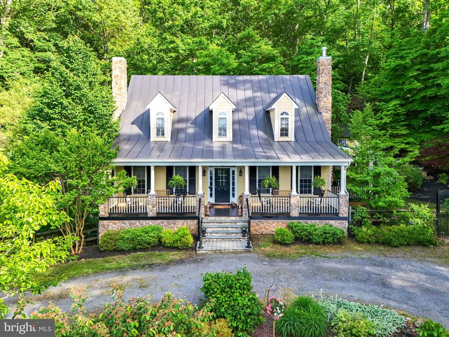 ***OFFER DEADLINE 10AM Sun 5/19***MULTIPLE OFFERS IN HAND****
This picture perfect custom-built “Cape Cod meets farmhouse” is a beautiful fusion of functional cottage elegance and vintage grandeur. Hardie plank wood siding, perfectly pitched metal roof for those rainy summer nights, two stone chimneys flanking the front & side porches with custom bead board ceilings, recessed lights and ceiling fans. Inside the front door, with vintage hand-turn brass door ringer, sidelights and transom windows, the floors are solid hardwood reclaimed from a tobacco barn in Tennessee. They are a showpiece throughout the main and upper levels. Two main level antique fireplace hearths have been lovingly restored onsite and convey.
Brimming with charm and elegance this thoughtfully designed farmhouse-style kitchen has custom cabinetry, built-ins with recessed lighting and high-end finishes and detail. Brand new Bosch Dishwasher, Bertozzani Italian gas stove, built-in pantry with microwave and Miele coffee/espresso machine and farmhouse center island on casters. Vintage screen doors open up to the beautiful patio and heated pool surrounded by lush gardens and walkways to the thoughtfully placed outbuildings. Woodworking shed with electricity and double barn doors that serve as bar/refreshments window for poolside entertainment. The studio/office shed has served as a beautiful place of serenity and retreat with awning windows, an electric fireplace and endless possibilities for the next owners.
Main level primary suite with double French doors to a private porch, stacked stone fireplace, walk in closet and claw foot tub. Custom, double sink vanity, handmade Roman shade window treatments, vintage and sconce lighting are among the many unique and specialty touches throughout this extraordinary property. Every detail is curated and designed with function and elegance. Vintage touches and charm teeming from every corner and behind every door.
Up the stairs a very large, primary-sized bedroom and a third large bedroom share an elegantly appointed custom bathroom with walk-in shower, custom vanity piece and soaking tub. Both bedrooms feature dormer windows with access to plenty of storage spaces.
Hand crafted Slate tile floor on the lower level with walkout double French doors make this level of the home it’s own private oasis.  Beautifully crafted bonus room   currently being used as a 4th bedroom   with one of 2 fireplaces on the lower level, also offers versatile living space for a home office or gym. Fully customized and built-in entertainment center is an exquisite piece that heightens the level of grandeur.  No luxury spared in the 4-sided custom tile shower cave, dual shower head system, custom vanity and rich, warm colors and fabrics. Energy efficient double paned windows and Smart Eco Bee thermostats. Sound system with surround sound and ceiling mounted speakers add to the poolside & patio(s) entertaining on both the main and the lower levels. 
This exceptional .67 acre property is a private place of tranquility and retreat that abuts protected forestry land. Landscaped with climbing wisteria, blooming azaleas, creeping Jenny and myriad wild and wonderful greenery with private, circular driveway yet 800 feet to the center of town. Steps to the local coffee shop, the spa, shopping and local fine eateries yet worlds away from the madding crowds. Don’t miss this once in a lifetime opportunity to live a dream in classic charm and sophistication in the country.  

​**Most furnishings are for sale and negotiable outside of the real property sale
<>LEAFGUARD GUTTER SYSTEM 2021<>WHOLE HOUSE PAINTED 2023<>POOL & EQUIPMENT SERVICED 2024<>CHAIRLIFT TO LOWER LEVEL CONVEYS<>4 PROPANE FPs <> NO HOA<>

​***15 mins to Salamander Resort & Spa***25 mins to Front Royal and Kayak/white water sports***28 mins to Shenandoah National Park***40-45mins to Winchester, Leesburg & Culpeper***50 mins to Kennedy Center & Downtown D.C.