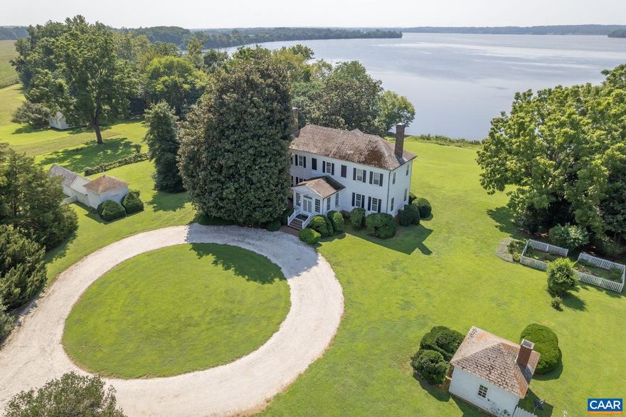 Nanzatico-18th century estate home built in 1765 sits within its own private bay, ensconced by a giant tulip poplar, boxwoods, and magnolias. Upon entering the main house you are met with a breathtaking view of the bay. Believed to have been the work of master builder William Buckland, Nanzatico has 70+ acres with original, historic, outbuildings including the perfect guest cottage with bedroom, full bath, kitchen and stone fireplace. There is also a 2 bay car garage and workshop.  The main house offers 3 bedrooms, 2 full baths, 1 half bath, a grand dining room, drawing room and living room. The woodworking and craftsmanship throughout are exceptional. Soaring ceilings, 6' mantles with large fireplaces, carved wooden cornices and classic archways. A piece of history within your own secluded, protected and private bay. Surrounded by wildlife, river views and tranquility only 15 minutes to King George and 1.5 hours from busy D.C.,Cherry Cabinets,Fireplace in Basement,Fireplace in Bedroom,Fireplace in Den,Fireplace in Dining Room,Fireplace in Family Room,Fireplace in Master Bedroom