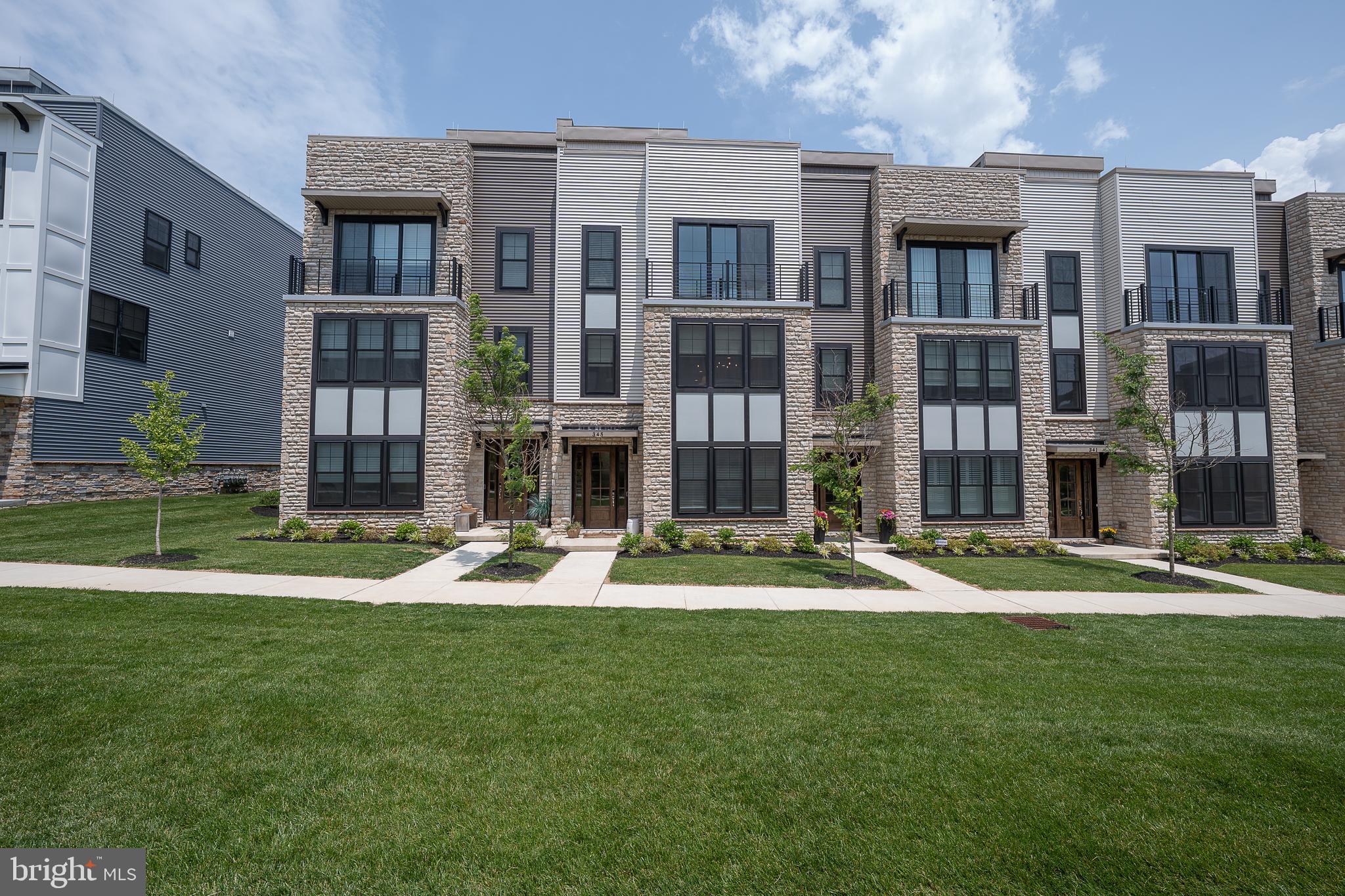Spend more time enjoying all that life has to offer. Experience the epitome of modern living with an open floor plan. This exceptional townhome is move in and ready for you to make it your own. In pristine condition this townhome is nestled in the sought after community of The Towns at Newtown Walk. This home boasts 3 bedrooms with a first floor bedroom/office with en suite bath. The primary bedroom has a beautiful bathroom with a large walk in closet. An additional en suite guest bedroom in located on the same level as the primary. A gourmet kitchen awaits you with 42" cabinets, quartz counter-tops, upgraded appliances and a center kitchen island .The dining area of the kitchen features a built in buffet with ample storage for your china and serving pieces. A cozy living area with gas fireplace is the perfect spot to relax and unwind. The living area features an upgraded mantel as well as built in bookshelves.This contemporary 3 story townhouse has a private 4 stop elevator with access to your private rooftop deck for entertaining and lounging. Enjoy the panoramic views of suburbia. This townhome also has a 2 car garage with plenty of room for storage, Enjoy the convenience of walking to Whole foods and many exceptional restaurants such as Ruth Chris and Sedona to chose from. Whether you are buying your first home, relocating to this area or even downsizing and looking for low maintenance modern amenities, this special property is not to be missed. Call me for a private tour. Quick delivery-Move-in ready.