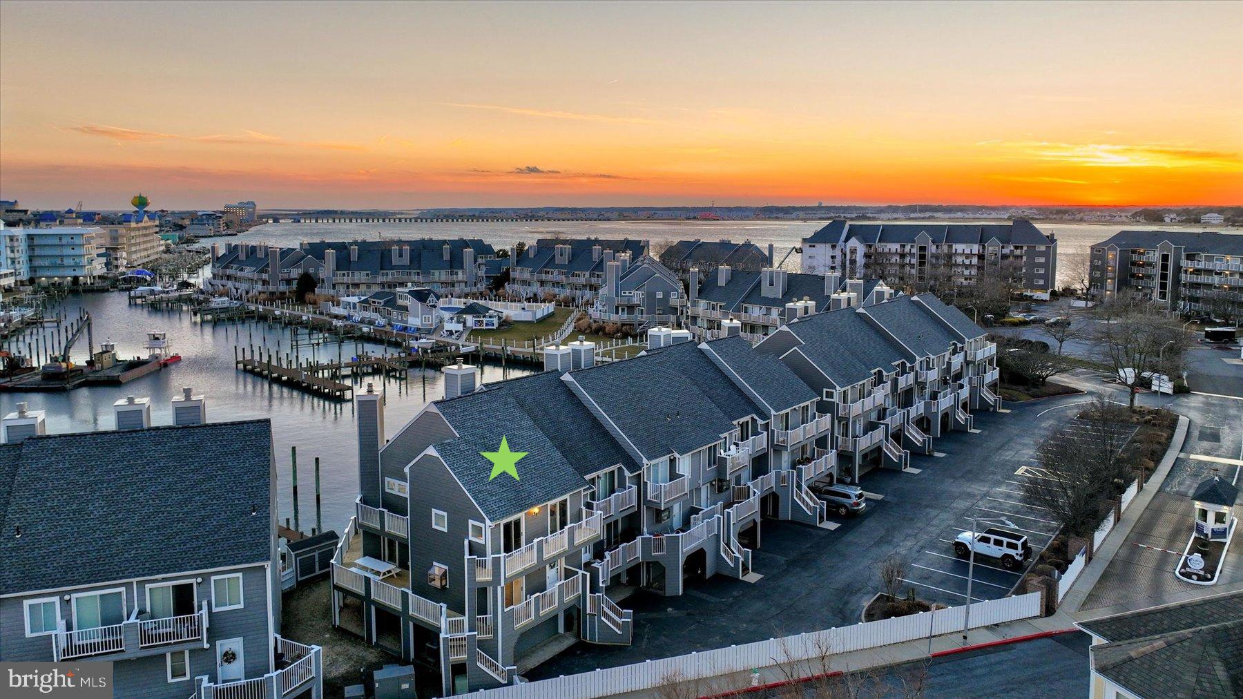 OPEN HOUSE SATURDAY, FEBRUARY 8th!! Rare Opportunity in Harbour Island End Unit Townhome with 2 SLIPS– Private deep-water boat slip #10 is 19'4" wide in front of unit and additional boat slip #106 conveys located on the bayside with a 10,000 lb boat lift. BRAND NEW SIDING and DECKING. COMPLETELY RENOVATED- HVAC, Roof, Windows, Doors, Interior. Home of the White Marlin Open and Reel Inn Bar & Restaurant! Community pool, tennis, playground, and pickleball. Welcome to 403 14th Street, #12 - Discover the pinnacle of luxury coastal living in one of Ocean City’s most coveted marina communities, Harbour Island. This newly renovated partially furnished end-unit townhome offers three spectacular levels of living and entertaining spaces, exquisitely crafted and thoughtfully designed to capture the essence of waterfront elegance. Step inside and be captivated by precise millwork, sunlit interiors, and a harmonious blend of fabulous finishes and sublime surfaces. Every detail of the renovation has been meticulously executed, showcasing luxury vinyl plank flooring, deep crown moldings, and striking staircases with steel cabling—sophisticated nods to the home’s coastal style and maritime roots. The main level is an entertainer’s dream, filled with natural light and breathtaking panoramic views of the marina. The gourmet kitchen is a chef’s delight, featuring stainless steel appliances, expansive Quartz countertops, crisp white cabinetry, and a spacious peninsula breakfast bar perfect for casual dining. Whether preparing meals or relaxing by the fireplace in the living room, the views will always steal the show. Step out onto the main level wrap-around deck, your private front-row seat to the renowned White Marlin Open. This expansive outdoor haven offers multiple zones for relaxation and dining, where from sunrise to sunset, views paint a stunning backdrop for every moment with a retractable awning. Retreat to the primary suite a tranquil oasis, complete with a luxurious spa-like ensuite boasting a spacious frameless glass stall shower, and access to a private balcony and deck—the perfect spot for your morning coffee or an evening toast to the day’s adventures. Two additional beautifully appointed bedrooms and a stylish hall bath complete this level. Both guest bedrooms offer private access to a connected wrap-around balcony/deck, providing comfortable spaces for family and friends. The lower level offers a versatile living space and dockside access. The lower level features a fourth bedroom with bonus space and a full bath, ideal for accommodating guests or creating a private retreat. This level also provides interior access to the oversized garage, ensuring convenience and storage for all your coastal essentials. Whether you’re setting sail for adventure or simply savoring the beauty of the marina, this residence is a gateway to unforgettable maritime experiences.