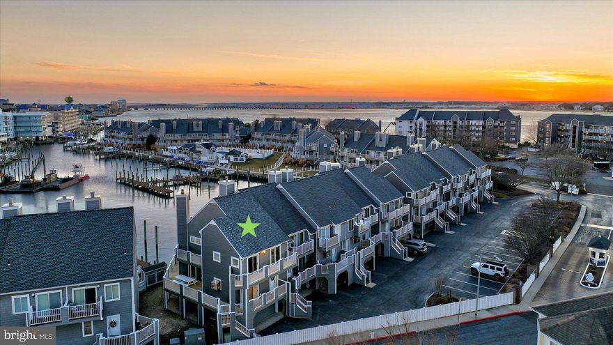 OPEN HOUSE SATURDAY, FEBRUARY 8th!!  Rare Opportunity in Harbour Island End Unit Townhome with 2 SLIPS– Private deep-water boat slip #10 is 19'4" wide in front of unit and additional boat slip #106 conveys located on the bayside with a 10,000 lb boat lift.  BRAND NEW SIDING and DECKING.  COMPLETELY RENOVATED- HVAC, Roof, Windows, Doors, Interior.  Home of the White Marlin Open and Reel Inn Bar & Restaurant!   Community pool, tennis, playground, and pickleball.  Welcome to 403 14th Street, #12 - Discover the pinnacle of luxury coastal living in one of Ocean City’s most coveted marina communities, Harbour Island. This newly renovated partially furnished end-unit townhome offers three spectacular levels of living and entertaining spaces, exquisitely crafted and thoughtfully designed to capture the essence of waterfront elegance. Step inside and be captivated by precise millwork, sunlit interiors, and a harmonious blend of fabulous finishes and sublime surfaces. Every detail of the renovation has been meticulously executed, showcasing luxury vinyl plank flooring, deep crown moldings, and striking staircases with steel cabling—sophisticated nods to the home’s coastal style and maritime roots. The main level is an entertainer’s dream, filled with natural light and breathtaking panoramic views of the marina. The gourmet kitchen is a chef’s delight, featuring stainless steel appliances, expansive Quartz countertops, crisp white cabinetry, and a spacious peninsula breakfast bar perfect for casual dining. Whether preparing meals or relaxing by the fireplace in the living room, the views will always steal the show. Step out onto the main level wrap-around deck, your private front-row seat to the renowned White Marlin Open. This expansive outdoor haven offers multiple zones for relaxation and dining, where from sunrise to sunset, views paint a stunning backdrop for every moment with a retractable awning. Retreat to the primary suite a tranquil oasis, complete with a luxurious spa-like ensuite boasting a spacious frameless glass stall shower, and access to a private balcony and deck—the perfect spot for your morning coffee or an evening toast to the day’s adventures. Two additional beautifully appointed bedrooms and a stylish hall bath complete this level. Both guest bedrooms offer private access to a connected wrap-around balcony/deck, providing comfortable spaces for family and friends. The lower level offers a versatile living space and dockside access. The lower level features a fourth bedroom with bonus space and a full bath, ideal for accommodating guests or creating a private retreat. This level also provides interior access to the oversized garage, ensuring convenience and storage for all your coastal essentials. Whether you’re setting sail for adventure or simply savoring the beauty of the marina, this residence is a gateway to unforgettable maritime experiences.