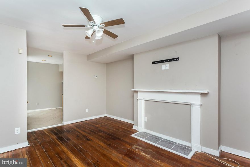 Ideal starter home located within steps of coffee shop, restaurants and Hollins Market.  Lower level fully separate entrance front  could be ideal in-law suite w/ galley kitchen.  Main house offers entrance living room, 1st flr laundry & bedroom.  Second level offers bedroom, office and full bathroom with two bedrooms on third level. Convenient to downtown, public golf course & transportation.