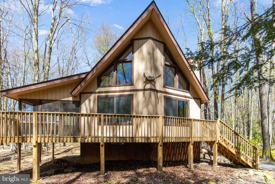 Discover this stunning 5-bedroom, 2.5-bath mountain chalet, perfectly situated on just under half an acre. Featuring a brand-new deck and a partially screened-in porch ideal for entertaining, this beautifully maintained home radiates vacation vibes. Located just a short walk or golf cart ride from the beach on Locust Village's second-largest lake, it's part of a vibrant, short-term rental-friendly community with 24-hour security and the only private ski lift in the area. Residents enjoy access to fishing, archery, birding, and ski clubs, plus weekly summer events for both kids and adults. Home is move in ready. Includes all furnishings, from major appliances and furniture to smallwares like dishes, glasses and bath towels. Cash flow ready! All just minutes from major ski resorts, golf courses, casinos, Pocono Raceway, indoor water parks, public hunting land, hiking, biking, and more.