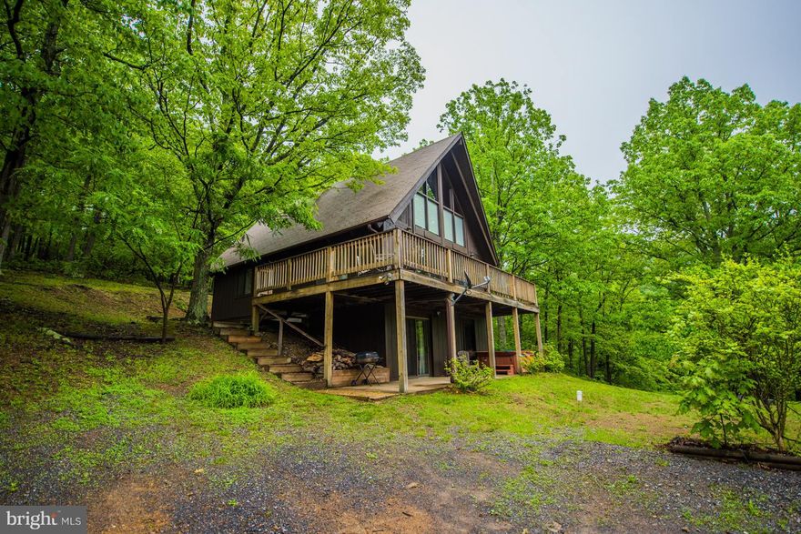 Very nice Chalet on 1.85 acres in town with public water and sewer.Overlooking the historic Berkeley Springs.surrounded by trees and private. Can be full time home, vacation getaway or rental..Large rooms and lots of space, large deck in front and decking in the rear. Just freshly painted inside and out. Close to all of downtown,spas,restaurants,state park,shopping and entertainment. Must see.