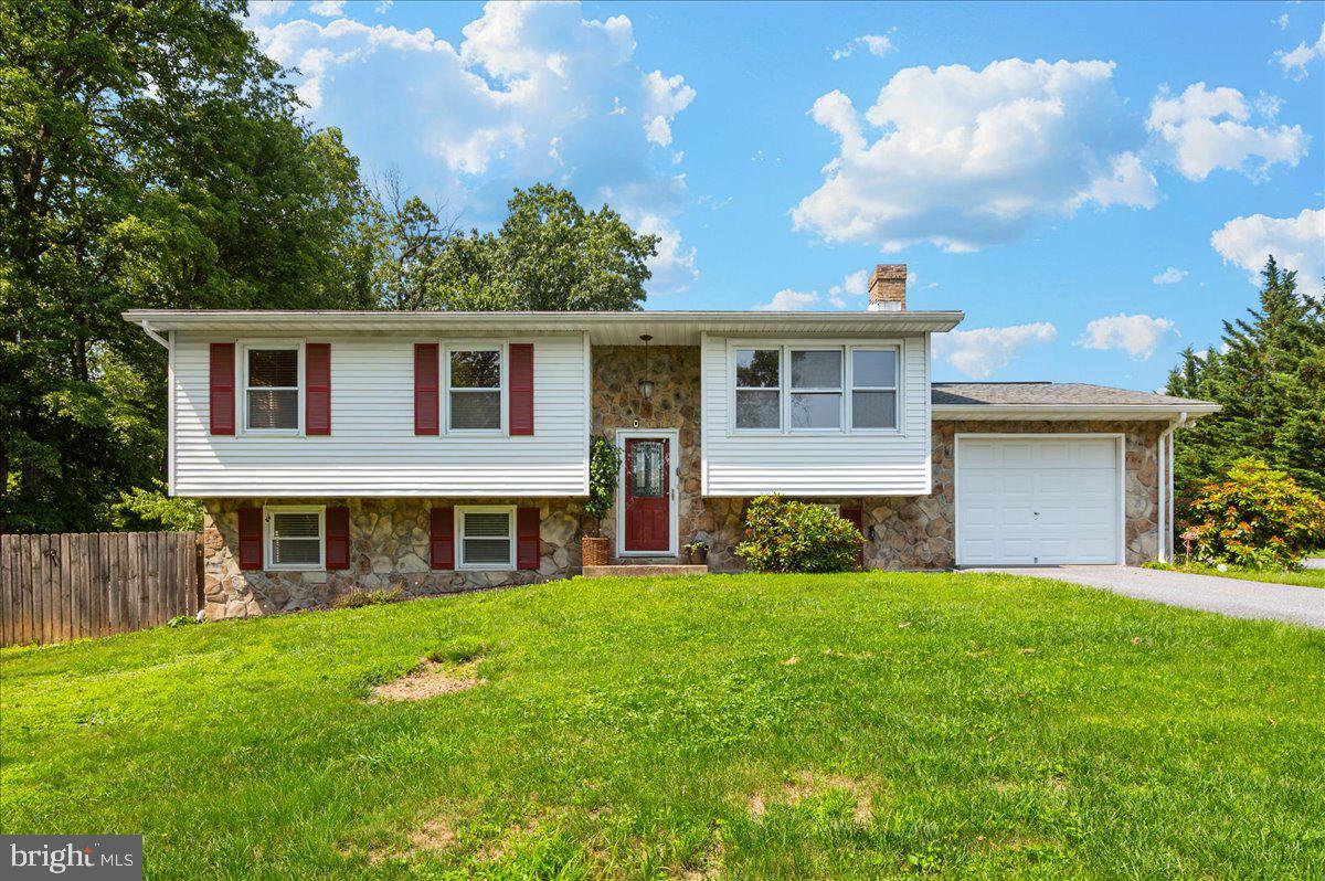 Welcome to a rare gem in Frederick that perfectly blends space, privacy, and modern updates. Set on nearly an acre with a fully fenced backyard, this 4-bedroom, 2-bathroom home offers a peaceful retreat while remaining just minutes from major routes, shopping, and dining. Step inside to discover a bright, open layout with freshly painted interiors and beautifully refinished wood floors, creating an inviting atmosphere ideal for both everyday living and entertaining. At the heart of the home, the renovated kitchen features granite countertops, elegant cabinetry, and stylish new light fixtures—an ideal space for cooking and gathering alike. The main level provides comfortable living areas filled with natural light, while the large, fully finished walkout basement offers endless possibilities for a recreation room, home office, or guest suite. Outdoors, this property truly shines. Enjoy your morning coffee or evening unwind on the 500 sq. ft. deck with a charming gazebo, all overlooking the lush and private backyard. For car enthusiasts or hobbyists, the oversized detached garage comes equipped with an air compressor, while the attached garage offers additional parking and storage options. A massive driveway easily accommodates multiple vehicles, boats, or even an RV, and a large shed provides extra storage for tools or seasonal items. With its combination of tasteful updates, expansive outdoor space, and exceptional functionality, this one-of-a-kind property is a must-see. Schedule your private tour today!