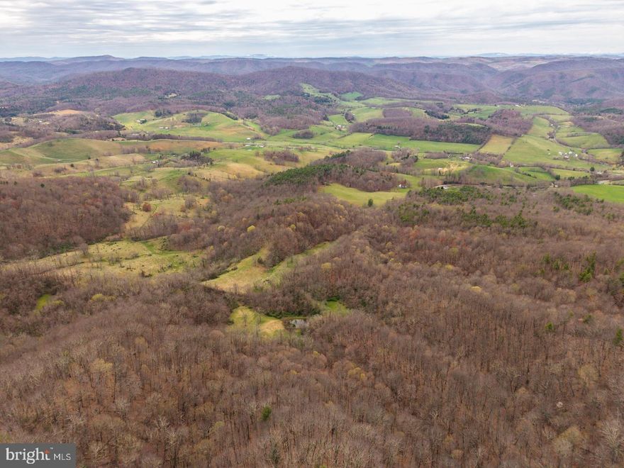 Perched atop Peter's Mountain on the border of West Virginia and Virginia in scenic Monroe County, this 15+/- acre off-grid retreat offers unmatched views and endless recreational opportunities. Tucked away along WV Highway 311, the property boasts direct road frontage and backs up to the vast expanse of the George Washington National Forest—providing instant access to thousands of acres of protected land. Whether you’re a hunter, hiker, or simply seeking solitude, this mountain sanctuary delivers. The hunting here is outstanding, and nearby public trout streams offer easy access to stocked waters. Explore a network of jeep trails, hike the legendary Appalachian Trail just minutes away, or simply relax and take in the panoramic views. From the west, gaze out across the lush expanse of the Sweet Springs Valley; to the east, overlook Potts Creek and Paint Bank—two of the most picturesque spots in the region. A small off-grid camp is already in place, making it the perfect basecamp for weekend getaways or a full-time off-the-grid lifestyle. With road access, forest frontage, and big mountain views in every direction, this property is a rare find in one of the most unspoiled corners of the Alleghenies.