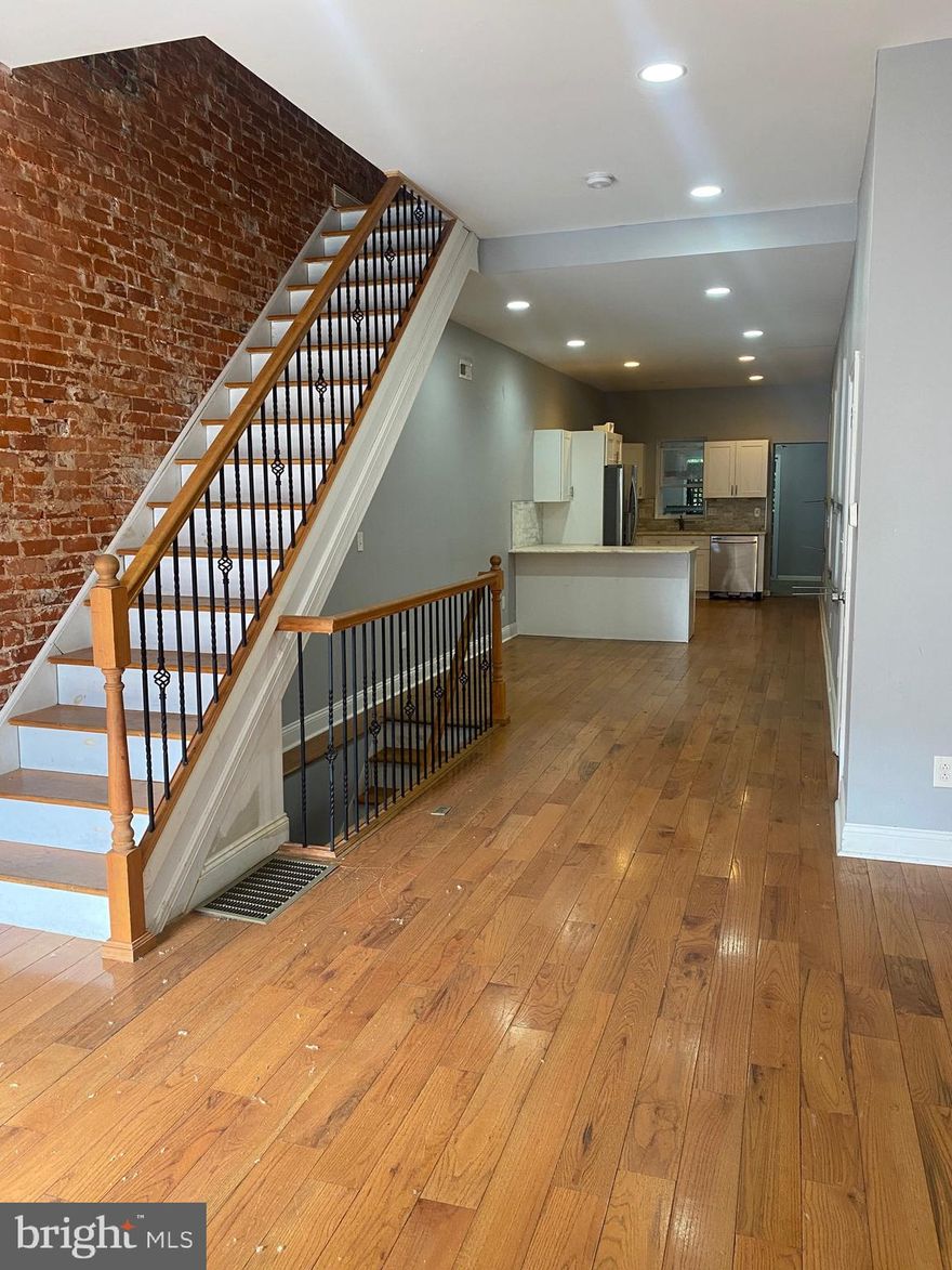 Welcome to 1732 N 29th Street located in Brewerytown! This Home has been recently renovated with many upgrades throughout! Walk into the Spacious main level with high ceilings, recessed lighting, many large windows, and Beautiful Hardwood Floors! The Exquisite exposed brick wall adds much character to this home! The  Interior Railings will for sure catch your eye with their Modern Iron and Wood Design! The Updated Kitchen has White Shaker Cabinetry, Peninsula Barstool Seating, Slow Close Drawers, Unique Countertops, and Stainless Steel Appliances. There is also a Powder room on the main level. The sliding glass doors in the Rear of the Home lead to the rear yard! The Second Floor has Three Spacious Bedrooms with Hardwood Floors. There is a full hall bathroom on the second floor. The Primary Bedroom has an exposed brick wall and it’s own on suite bathroom. Wall Mount Television Hook ups Throughout the Home. Property is Being Sold in "AS-IS" condition. Seller makes no guarantees or warranties regarding property, mechanicals, or appliances.