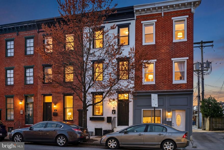 Fully renovated Federal Hill row home offering over 1,700 sq ft of thoughtfully designed living space in one of Baltimore’s most sought-after neighborhoods. This 4-bedroom, 2-bathroom home blends classic Baltimore architecture with modern finishes, featuring a new custom cornice, updated brick facade, and hardwood flooring throughout.

The sun-filled main level benefits from all the windows, creating a bright and welcoming atmosphere. The galley kitchen is appointed with quartz countertops, stainless steel appliances, and ample cabinetry, opening to a dedicated dining area ideal for everyday living and entertaining.
The second and third levels each host two bedrooms and a full bathroom, offering a flexible layout that easily accommodates a primary suite floor, home office, or guest space. In-unit laundry is conveniently located on the second level.
A private parking pad provides off-street parking in the heart of the city with an EV plug in. Walkable to Inner Harbor, restaurants, shops, and entertainment, with quick access to I-95.